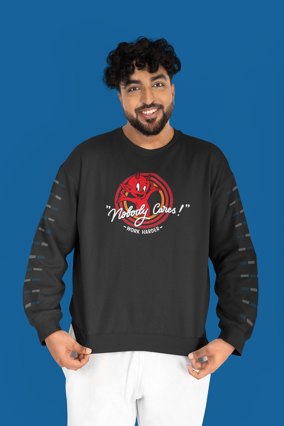"Nobody Cares, Work Harder" devil graphic sweatshirt in black, man wearing it on blue backdrop, funny gift for him