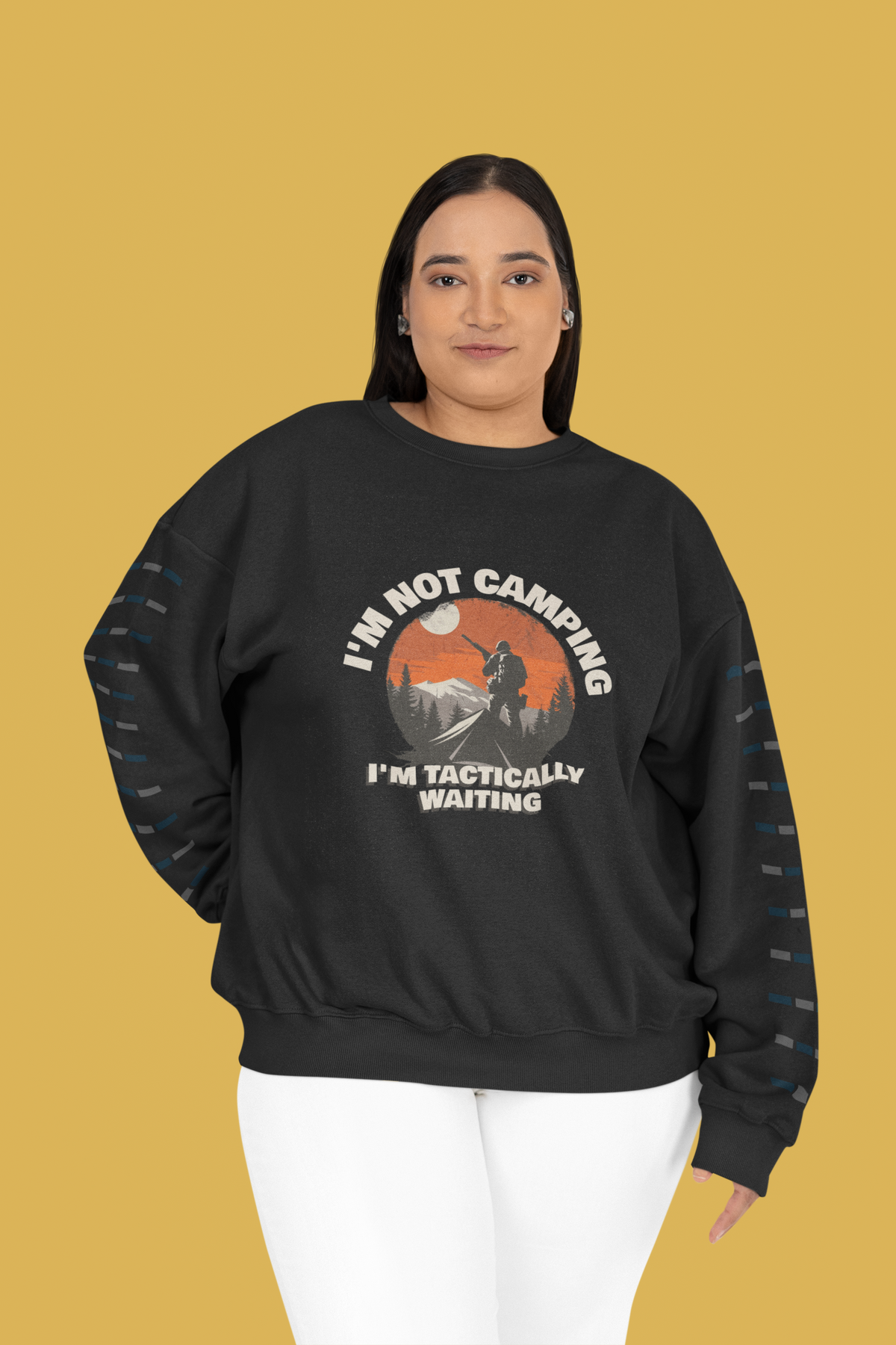 'I'm Not Camping' hiker graphic sweatshirt in black, plus size woman wearing it, mustard backdrop