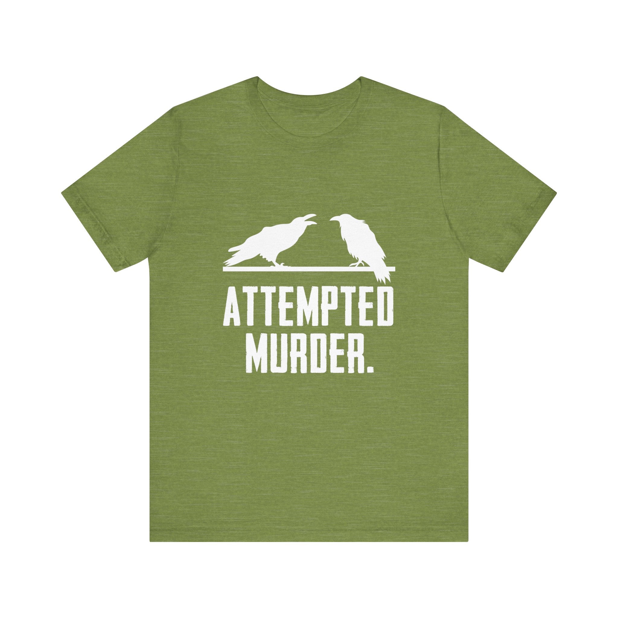 This chic and humorous Attempted Murder T-Shirt showcases a green tee with two crows facing one another above the phrase "Attempted Murder," adding a touch of humor and style to your wardrobe.