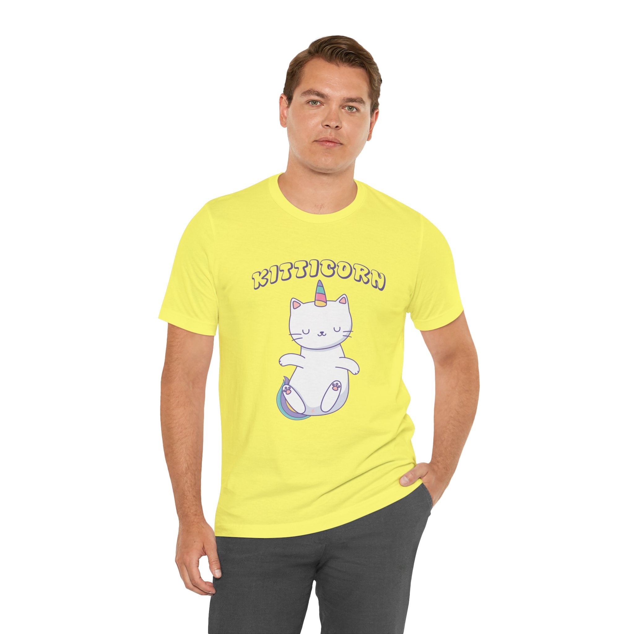 Man in a bright yellow unisex Kitticorn tee featuring a "kitticorn" graphic with quality print, standing against a plain white background.