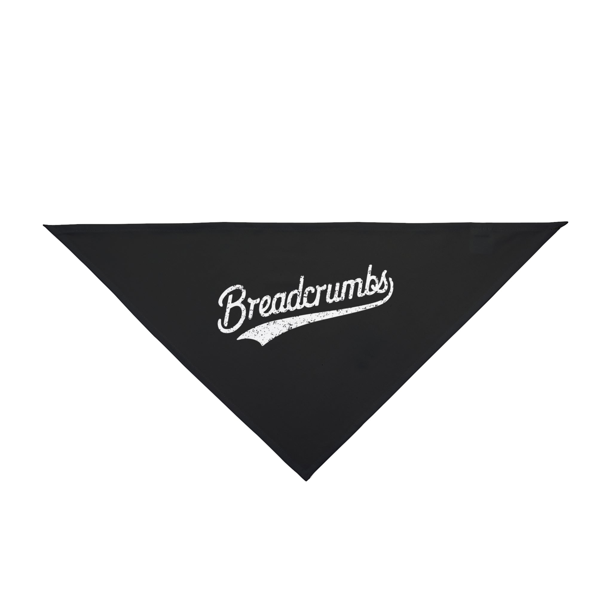 A black Breadcrumbs - Pet Bandana, designed in a triangular shape with "Breadcrumbs" written in cursive white text in the center, made from soft-spun polyester.