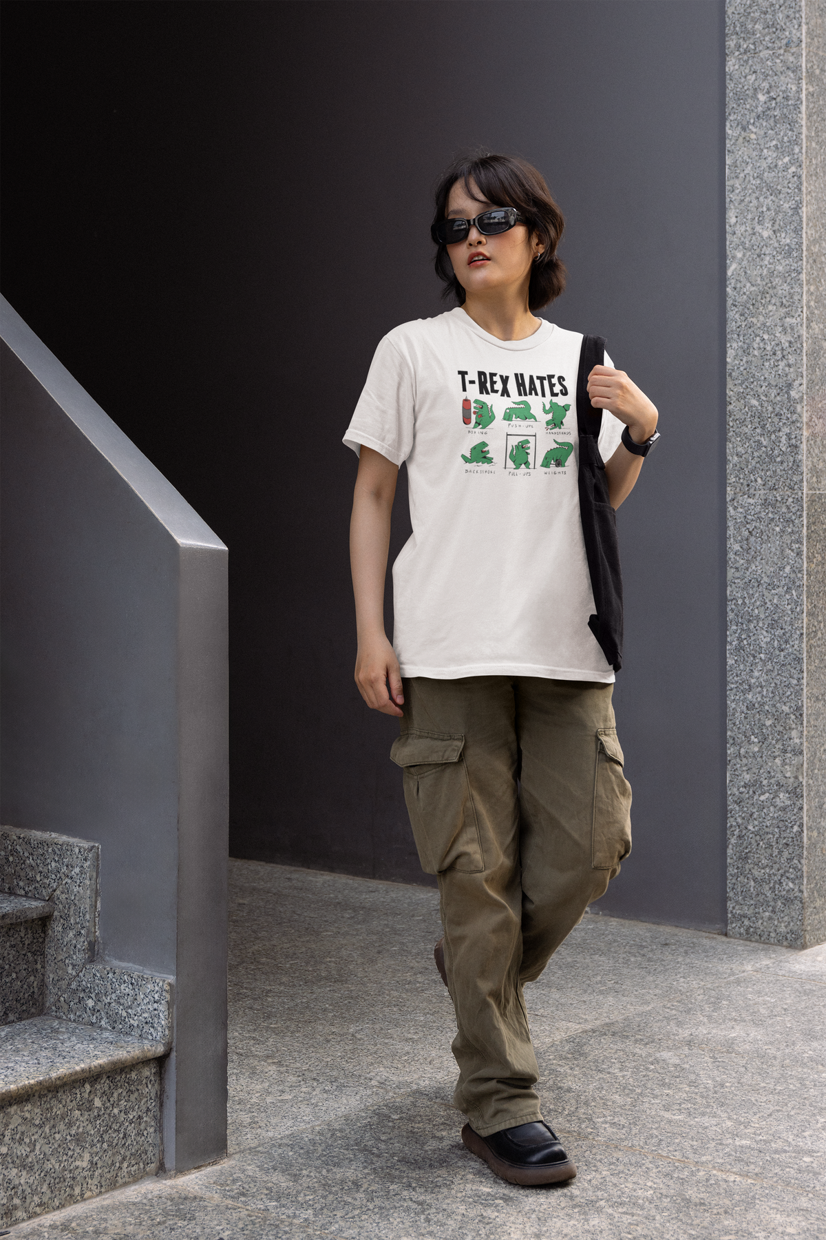 'T-Rex Hates' women's t-shirt in white, woman walking outdoors wearing it, dinosaur pun gift
