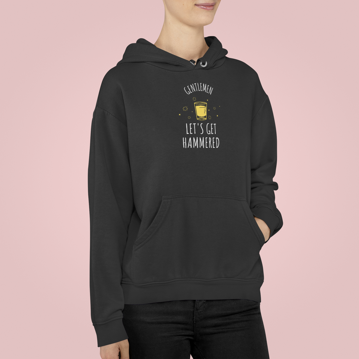 'Gentlemen Let's Get Hammered' text hoodie in black, woman wearing it against a pink backdrop, party gift