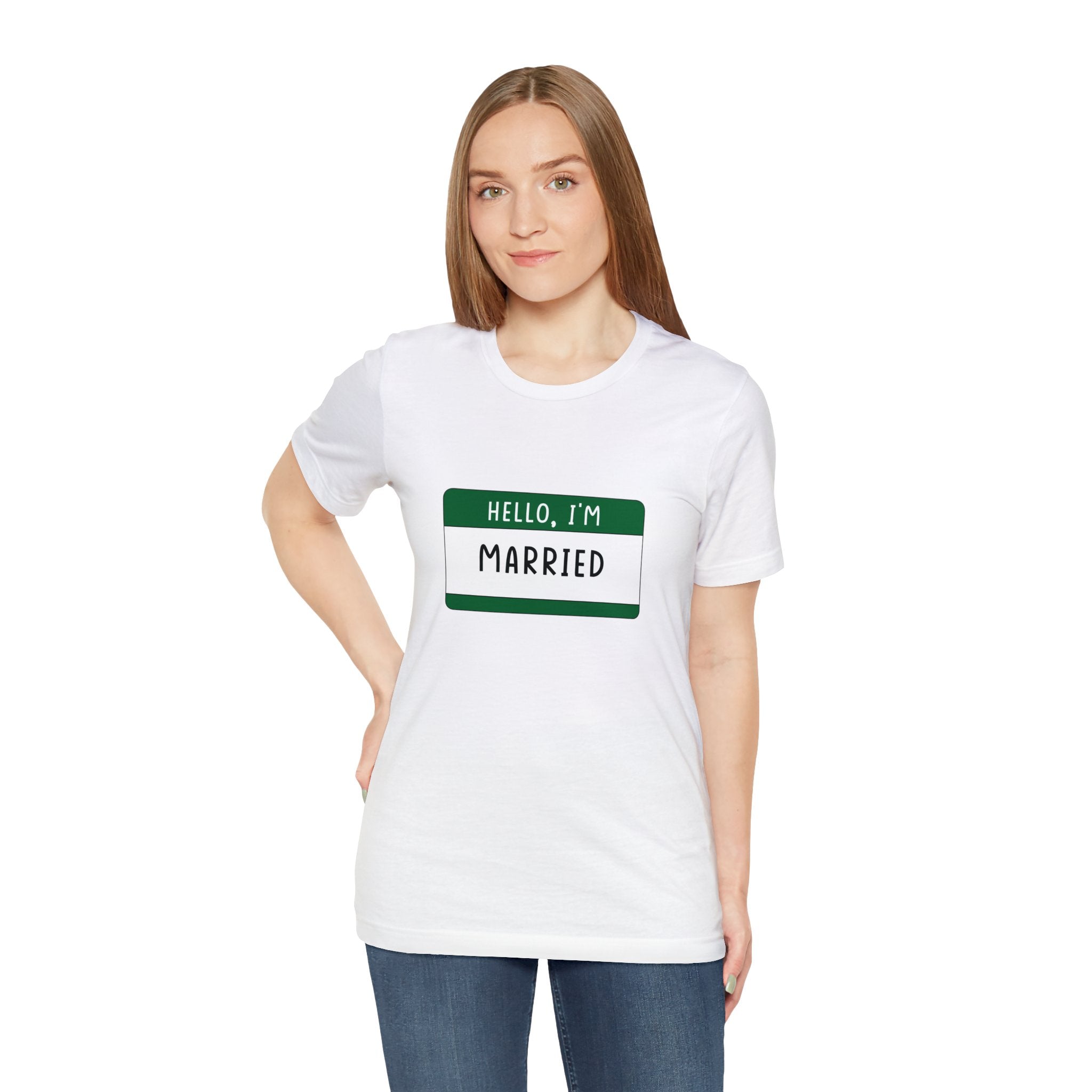 Woman in a white Hello, I'm Married T-Shirt with a green name tag standing against a plain background.