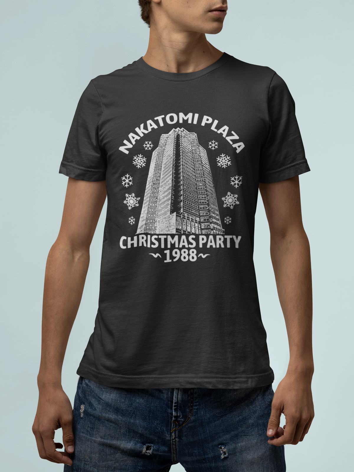 'Nakatomi Plaza Christmas Party 1988' t-shirt in black, man wearing it, Die Hard fan shirt gift