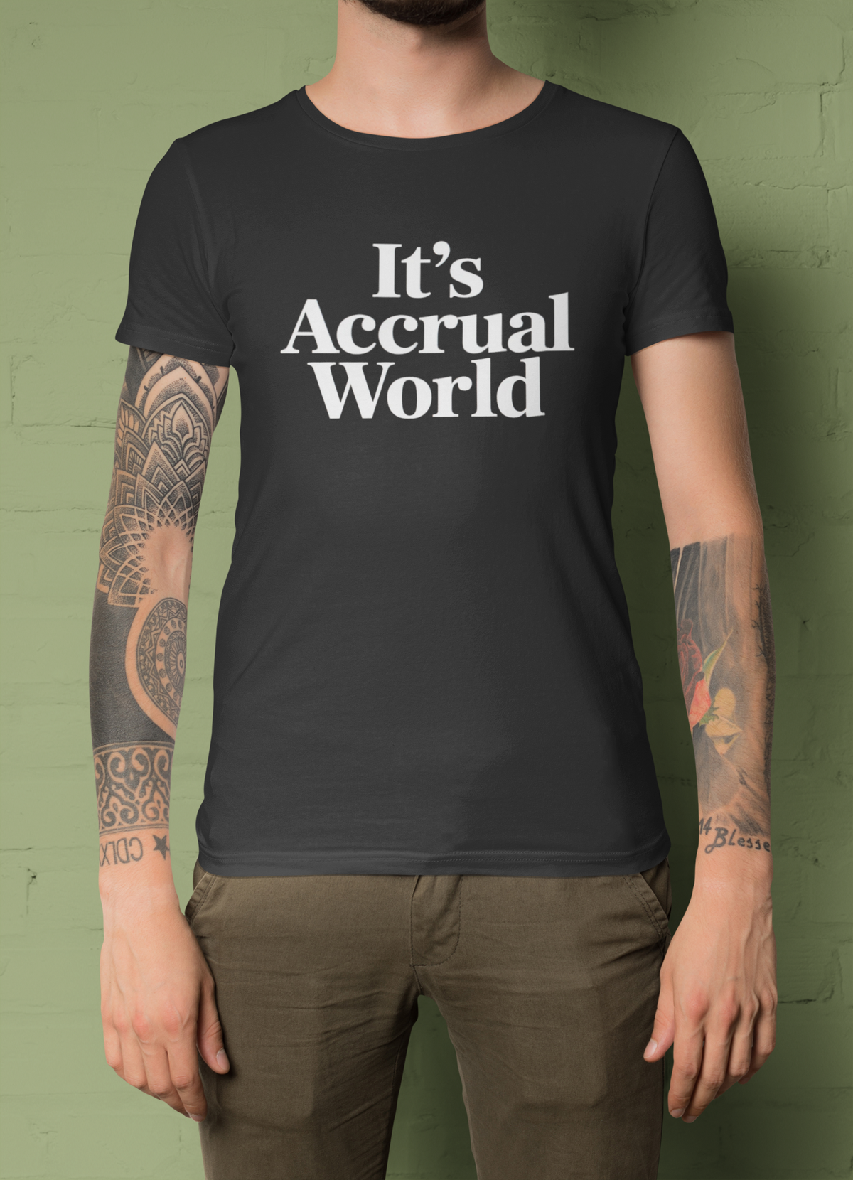 'It's Accrual World' t-shirt in black, close-up of tattooed man wearing it, funny accountant gift