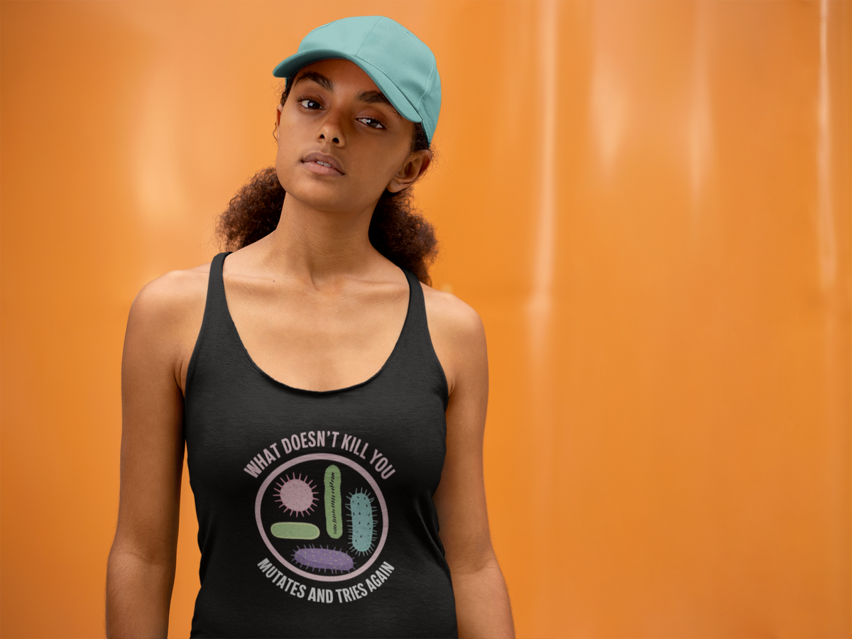 'What Doesn't Kill You' racerback tank top in black, woman wearing it by an orange wall, Tank Top mockup, Geekpsters