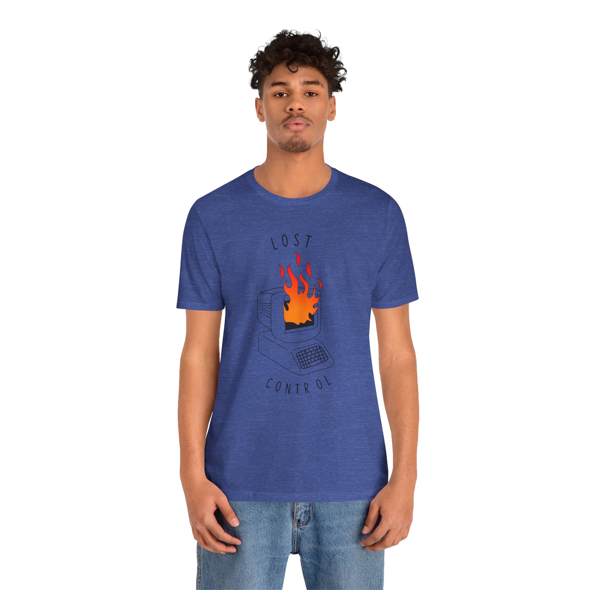 A person stands against a plain background, wearing the "Lost Control T-Shirt," crafted from high-quality cotton. This blue shirt showcases an illustration of a burning computer, providing both style and comfort.