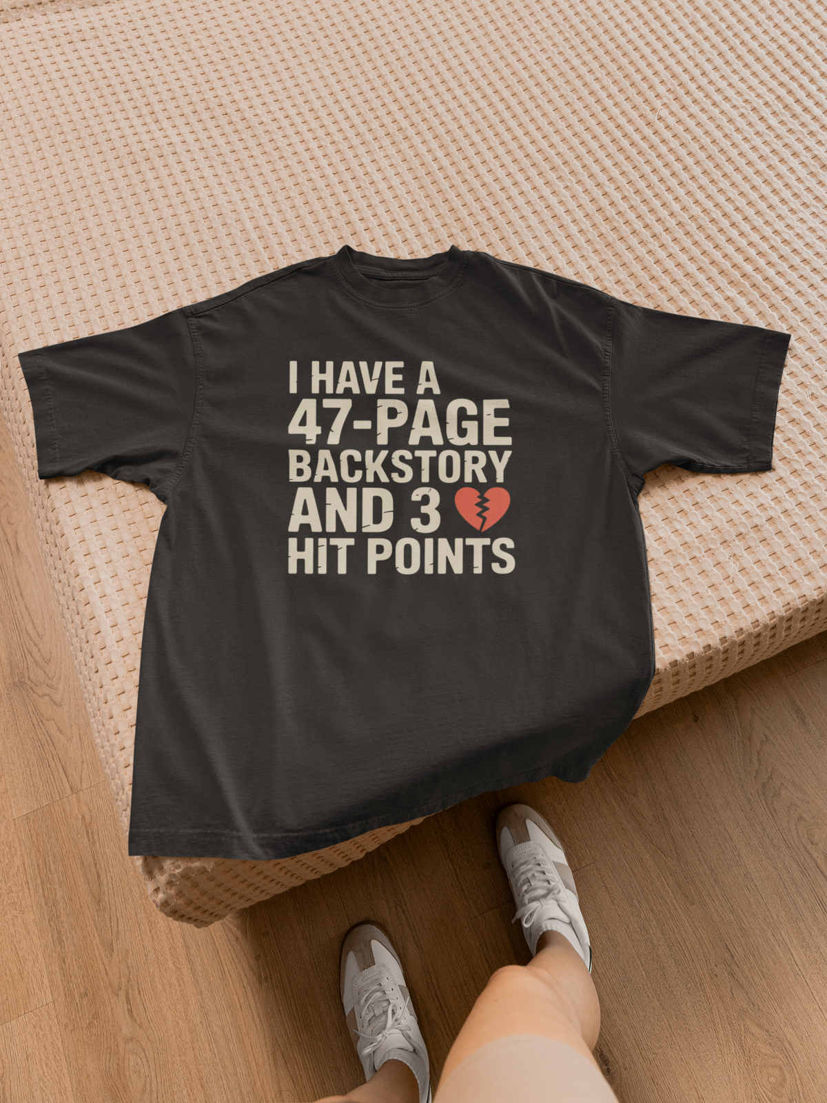 'I Have a 47-Page Backstory and 3 Hit Points' black tee laid on bed with sneakers, D&D gift idea