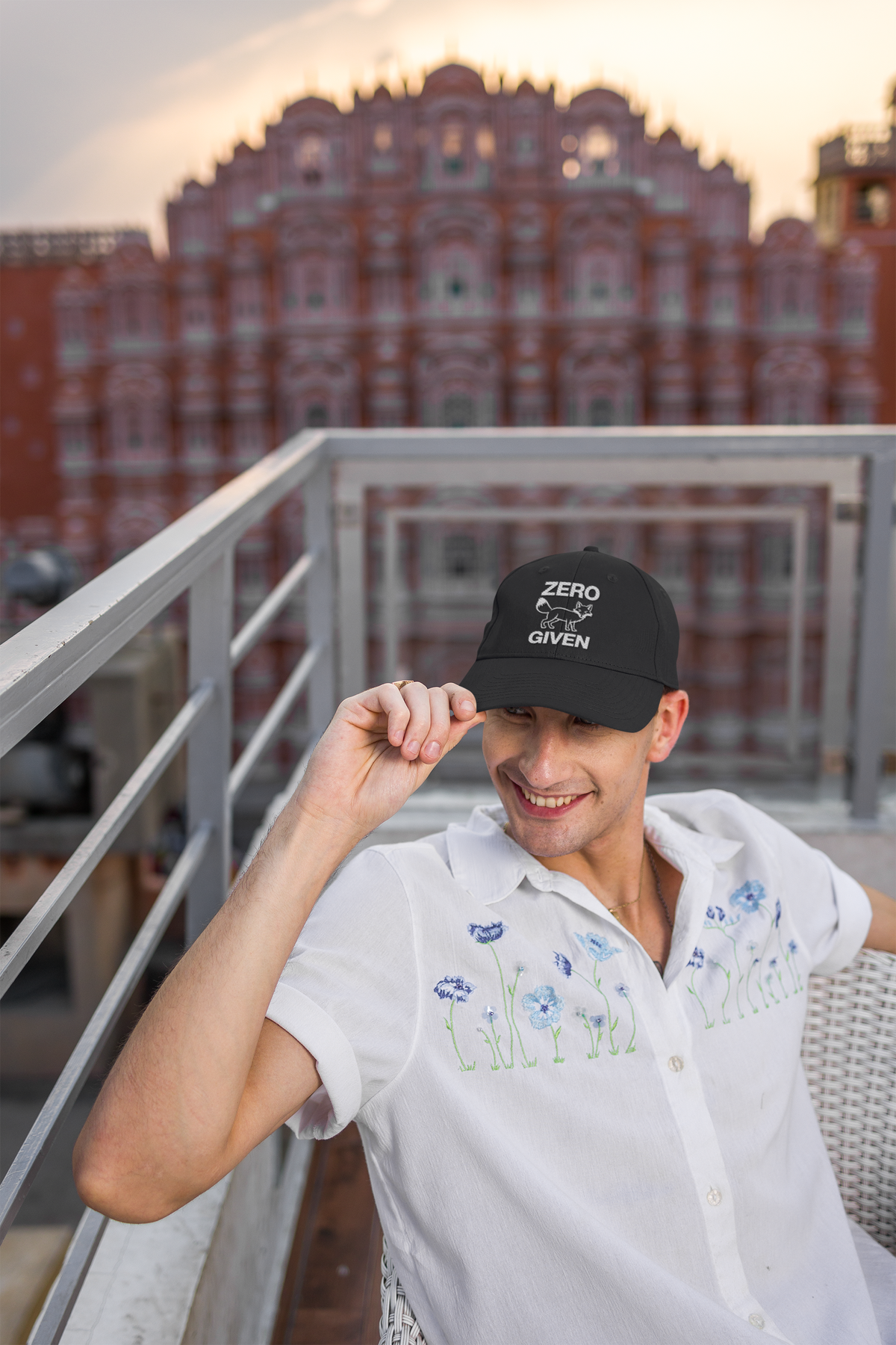 Zero Fox Given sarcastic dad hat, man on a city balcony, lifestyle mockup, Geekpsters