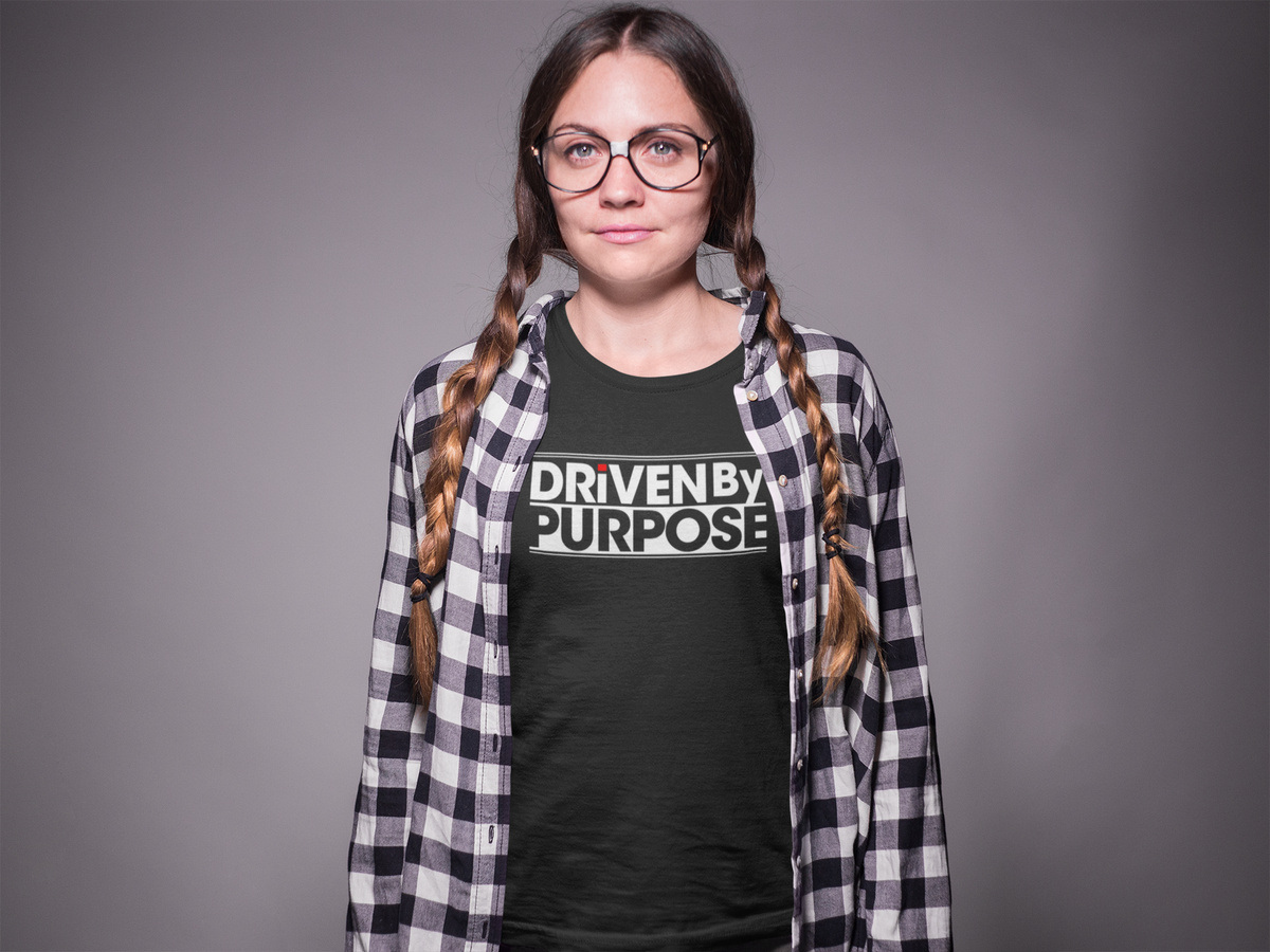 'Driven by Purpose' organic t-shirt in black, woman with braids wearing it in studio, inspiring gift