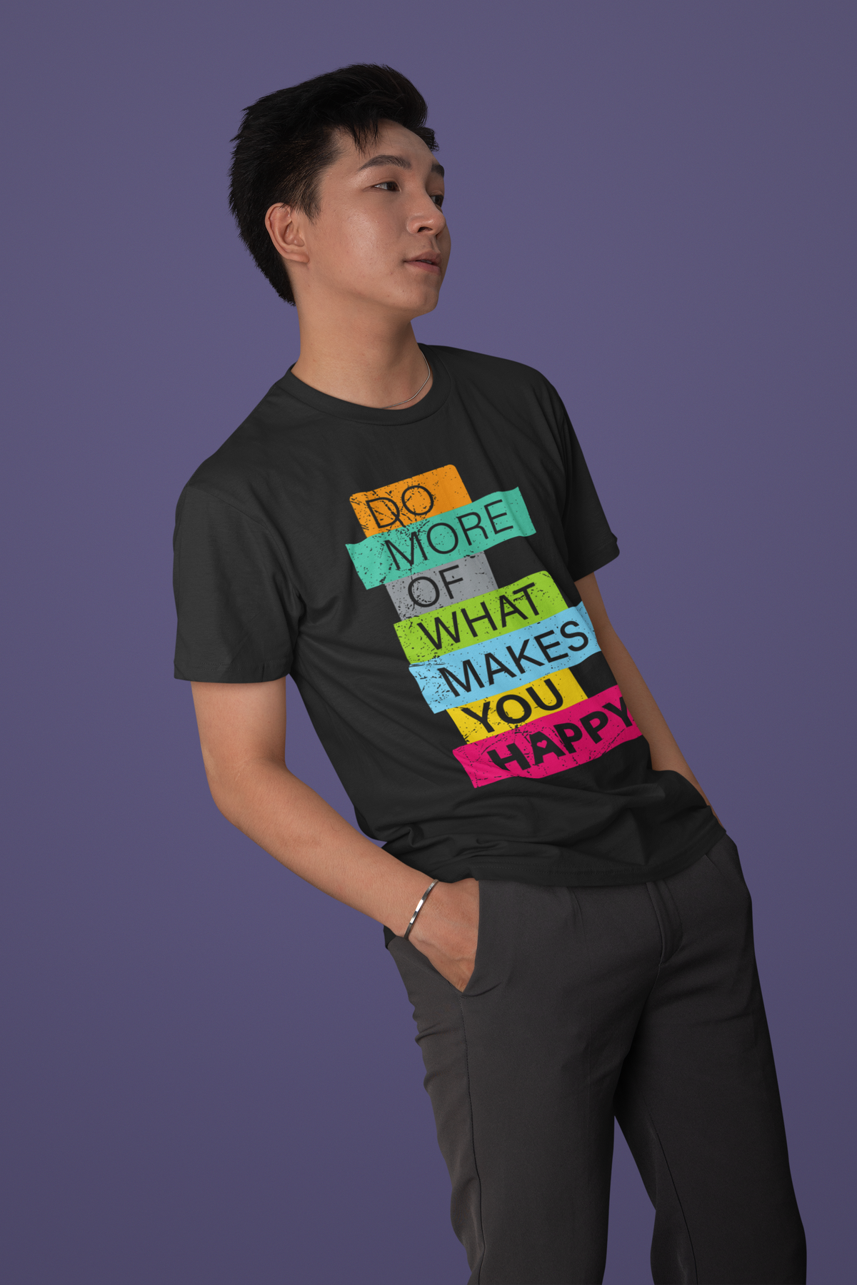 'Do More of What Makes You Happy' T-shirt in black, man wearing it against a purple backdrop, gift