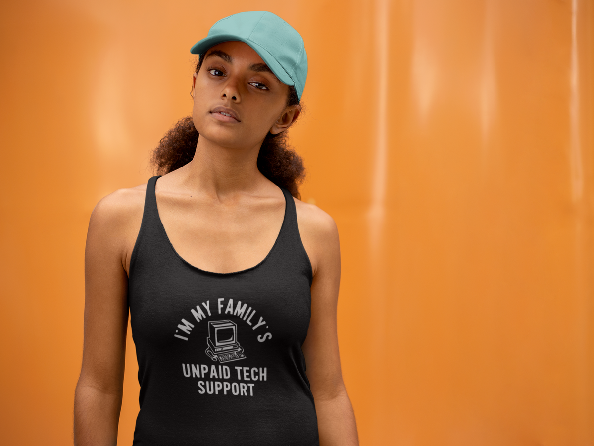 'I Am My Family's Unpaid Tech Support Tank' in black, woman by an orange wall, Tank Top mockup, Geekpsters