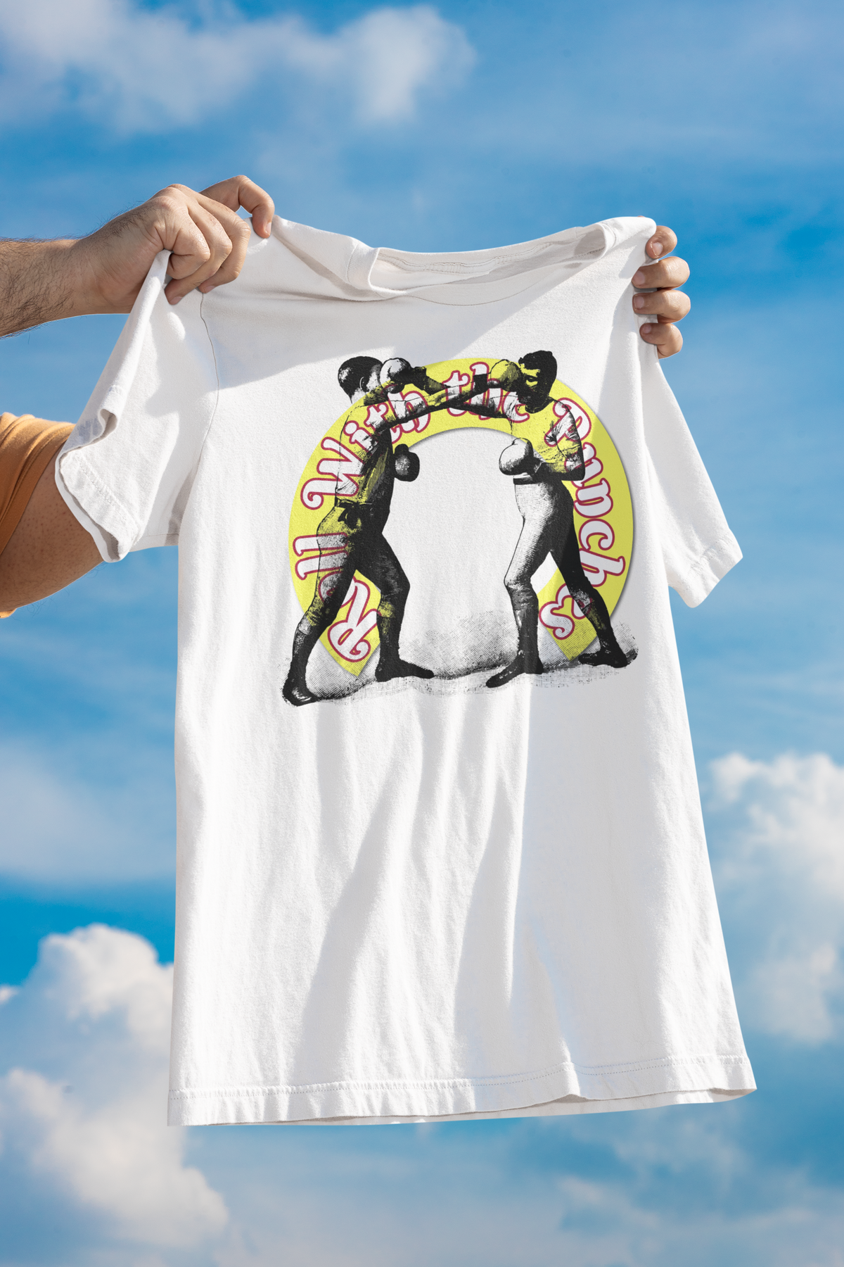 'Roll With The Punches' boxers t-shirt in white, held up against a blue sky, motivational gift shirt