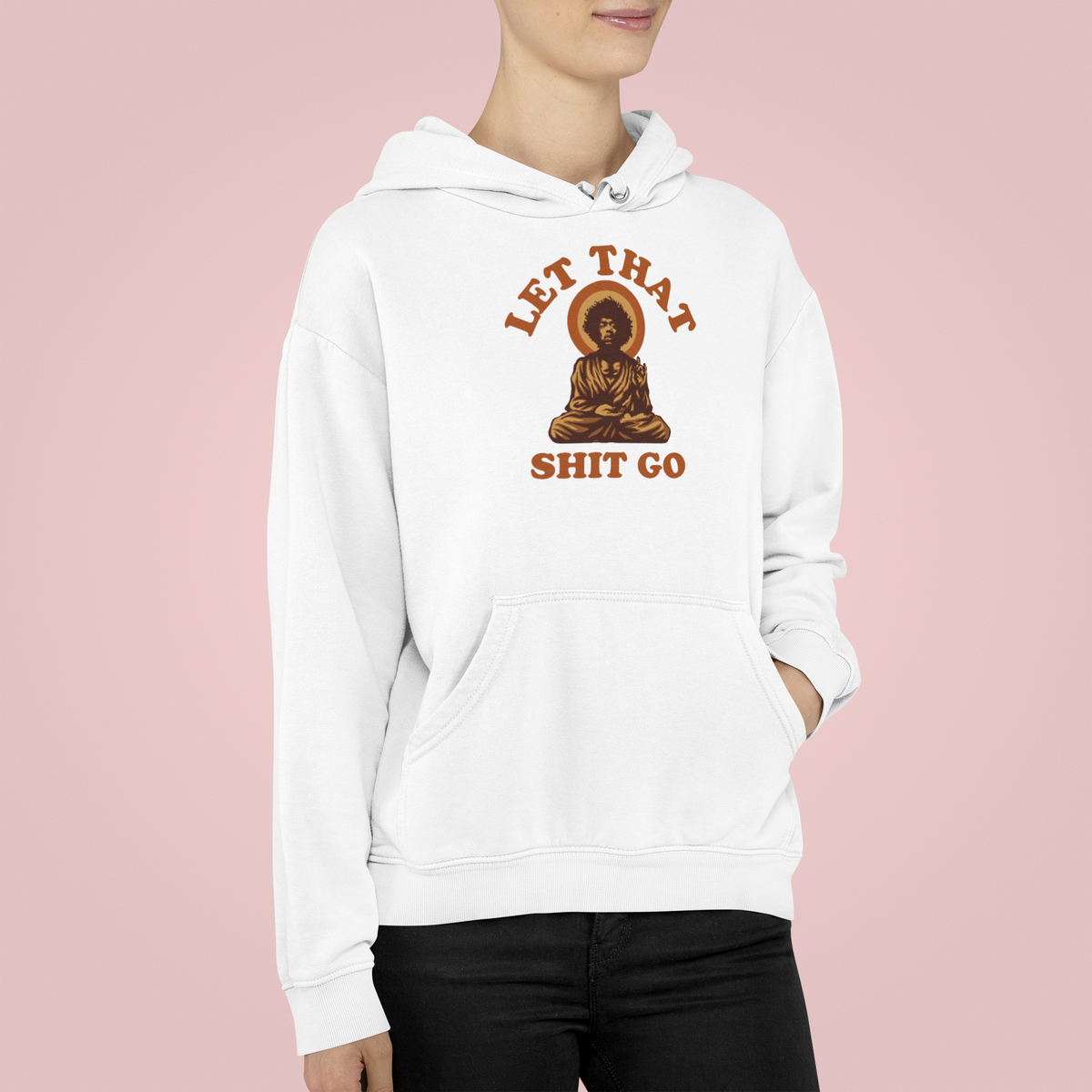 "Let That Shit Go" buddha graphic hoodie in white, woman wearing it on pink backdrop, funny gift for her