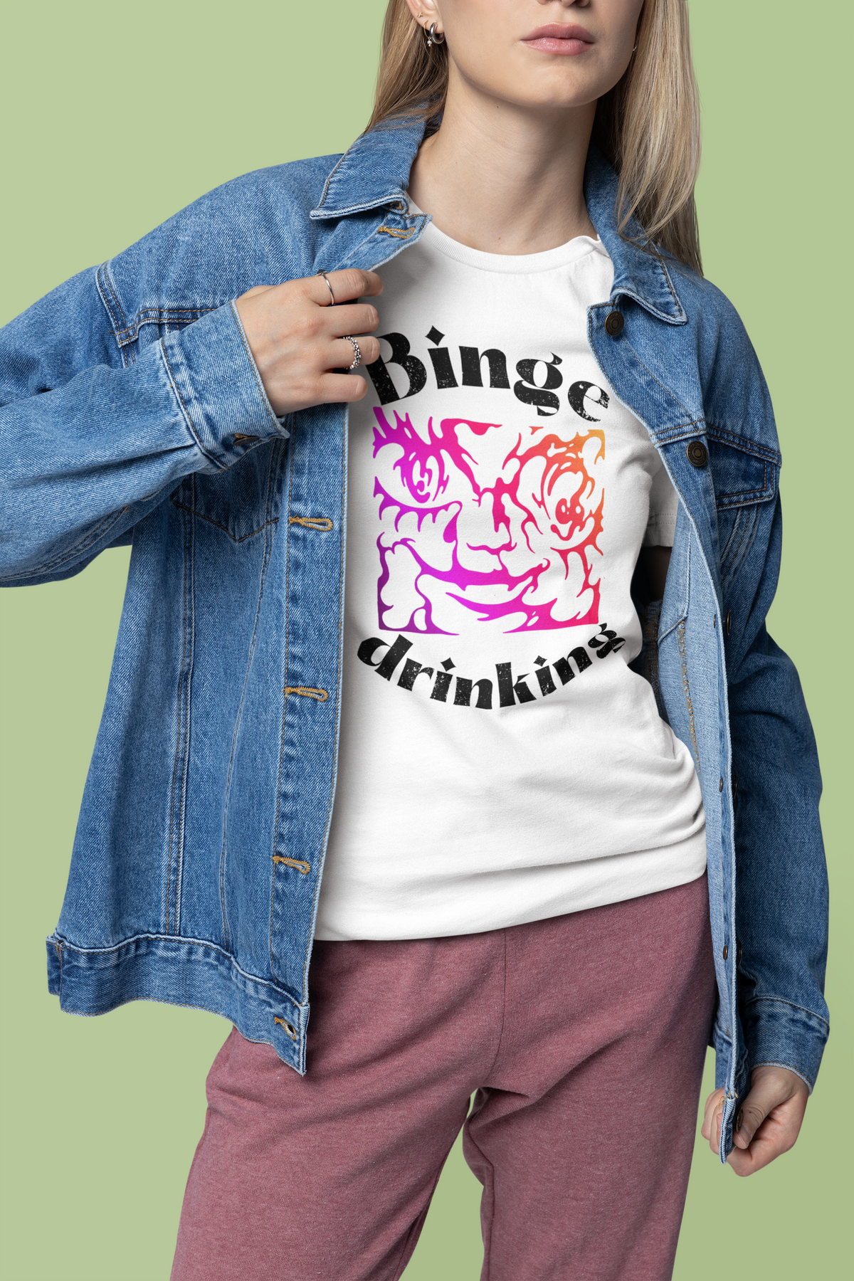 "Binge Drinking" graphic t-shirt in white, woman wearing it under a denim jacket, funny party gift