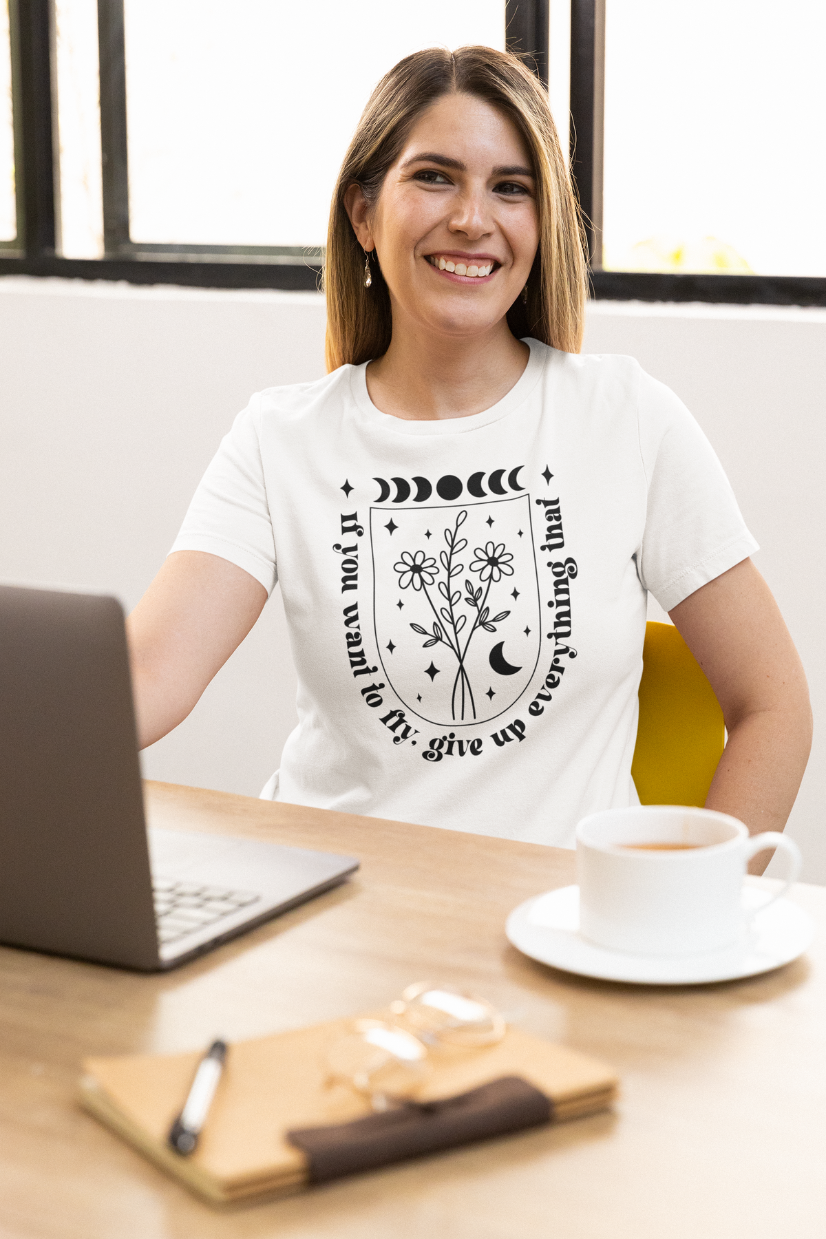 'If You Want To Fly' t-shirt in white, smiling woman at a desk wearing it