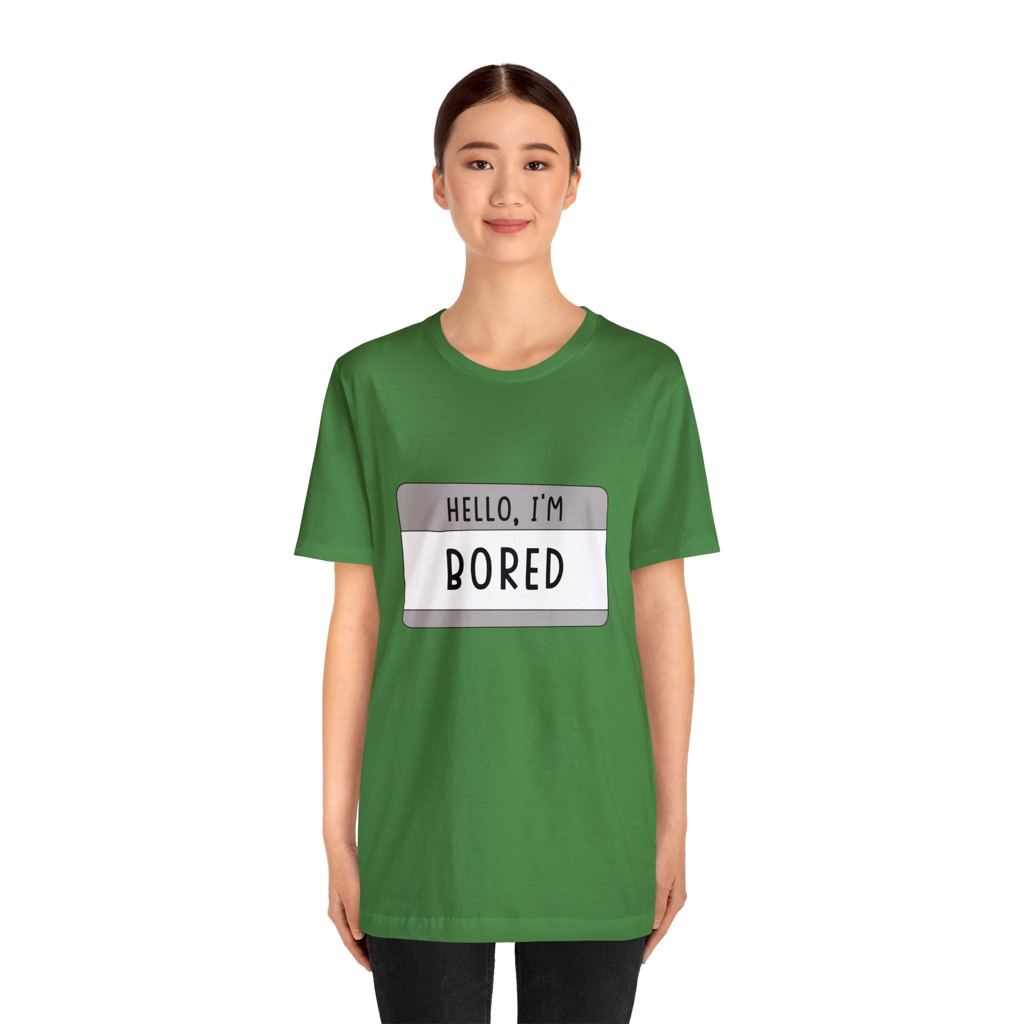A woman in a green tee-shirt that says "Hello, I'm Board" adds character to her outfit.