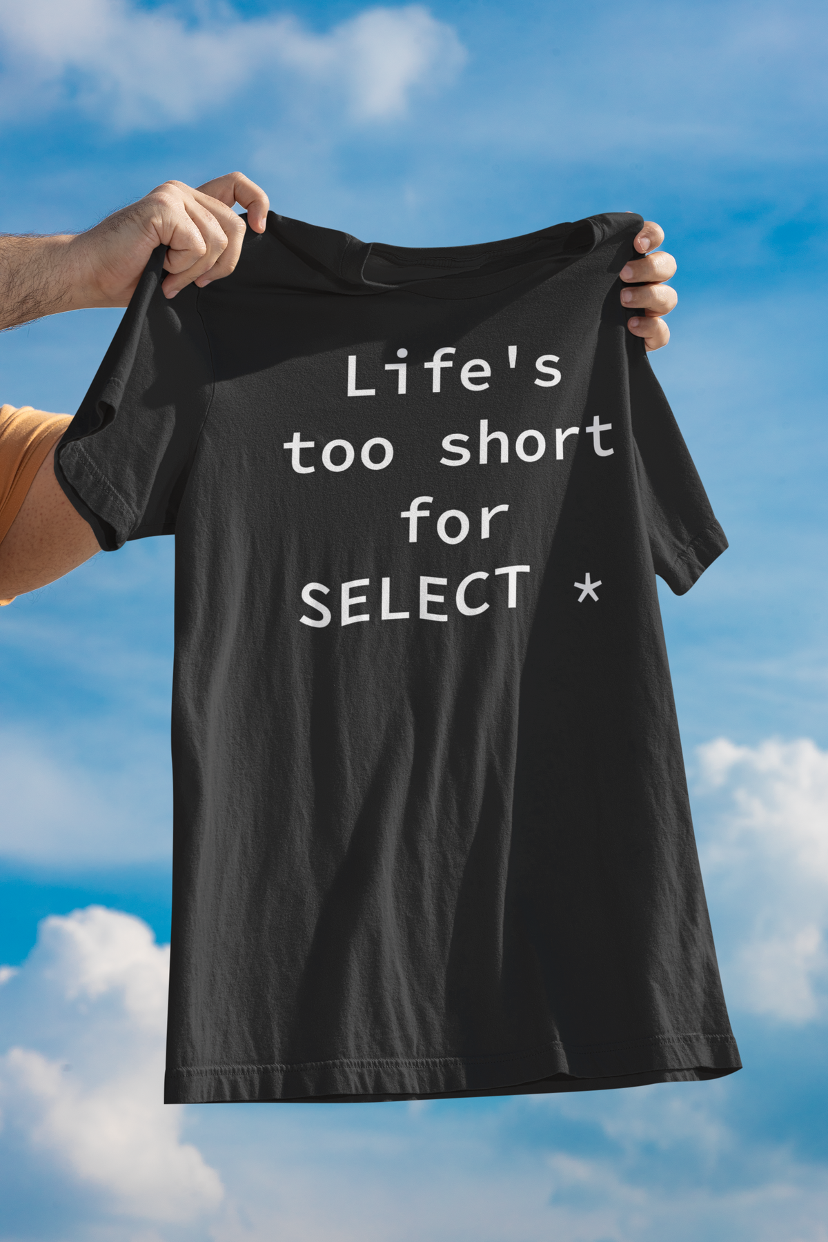 'Life's Too Short for SELECT *' t-shirt in black, man holding it up outdoors, funny gift for developers