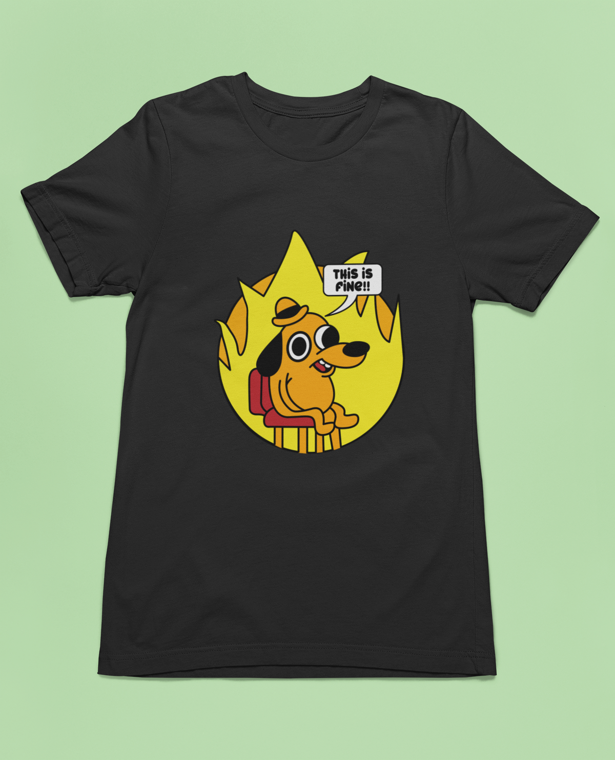 ‘This Is Fine’ meme dog black tee, flat lay on green backdrop, funny meme gift idea