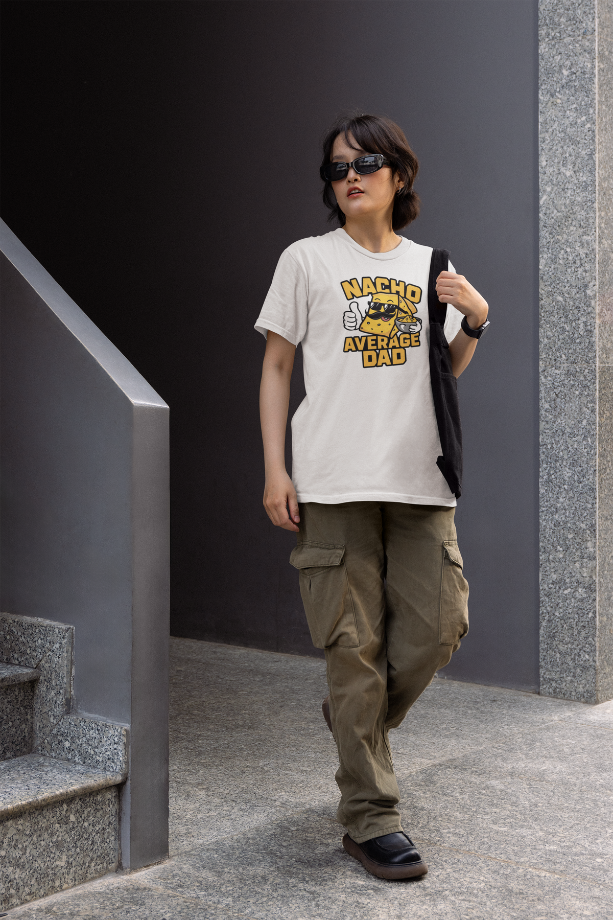 "Nacho Average Dad" women's tee in white, man walking outdoors near stairs, funny Father's Day gift