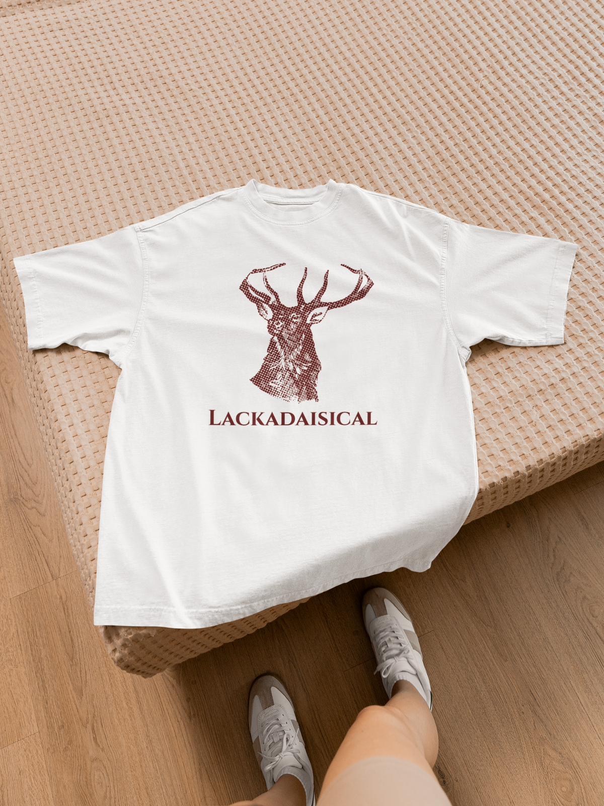'Lackadaisical' stag deer t-shirt in white, flat lay lifestyle setting, funny nature pun gift shirt