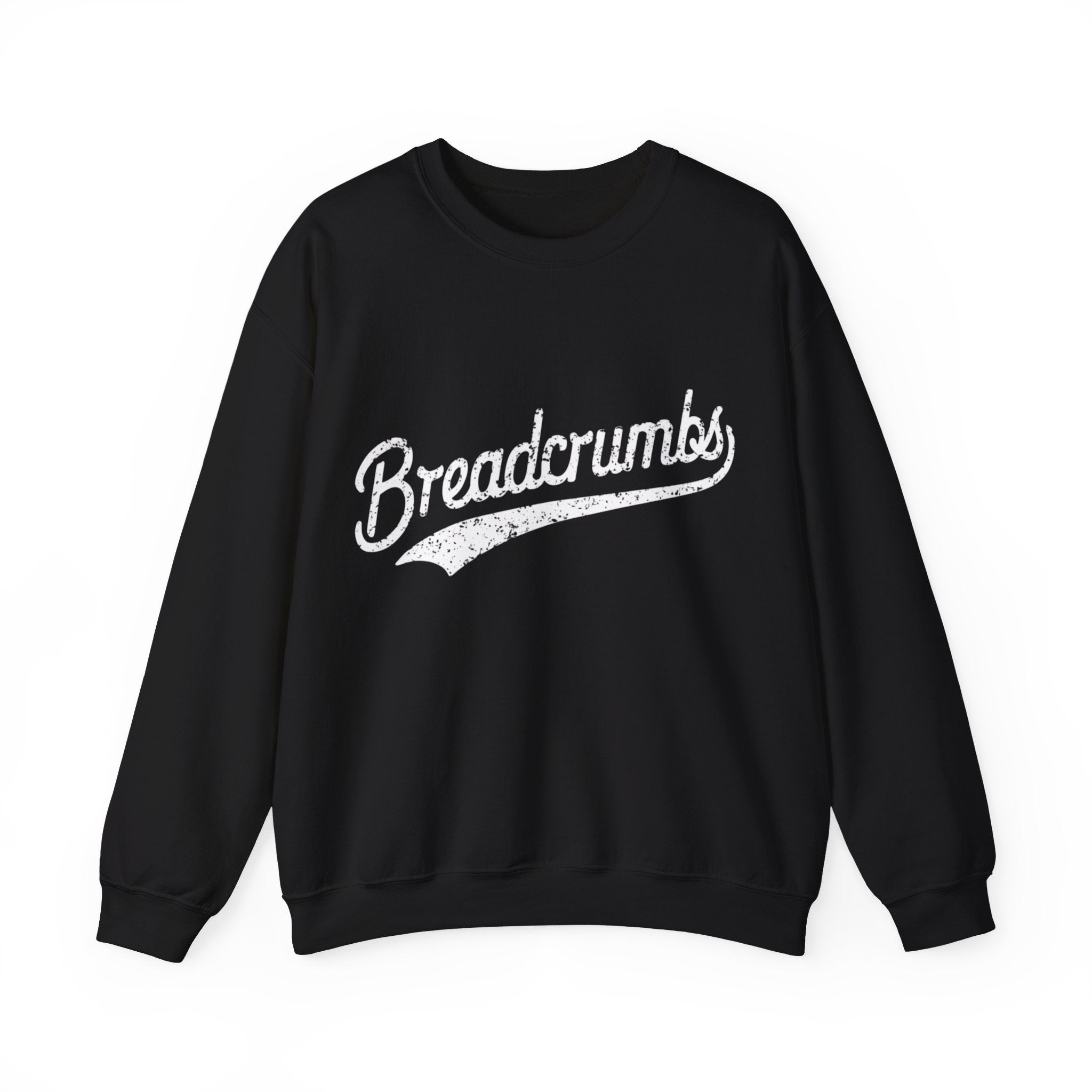 A cozy sweatshirt perfect for the colder months, this black piece features the words "Breadcrumbs - Sweatshirt" elegantly printed in white, styled in a cursive font across the front.