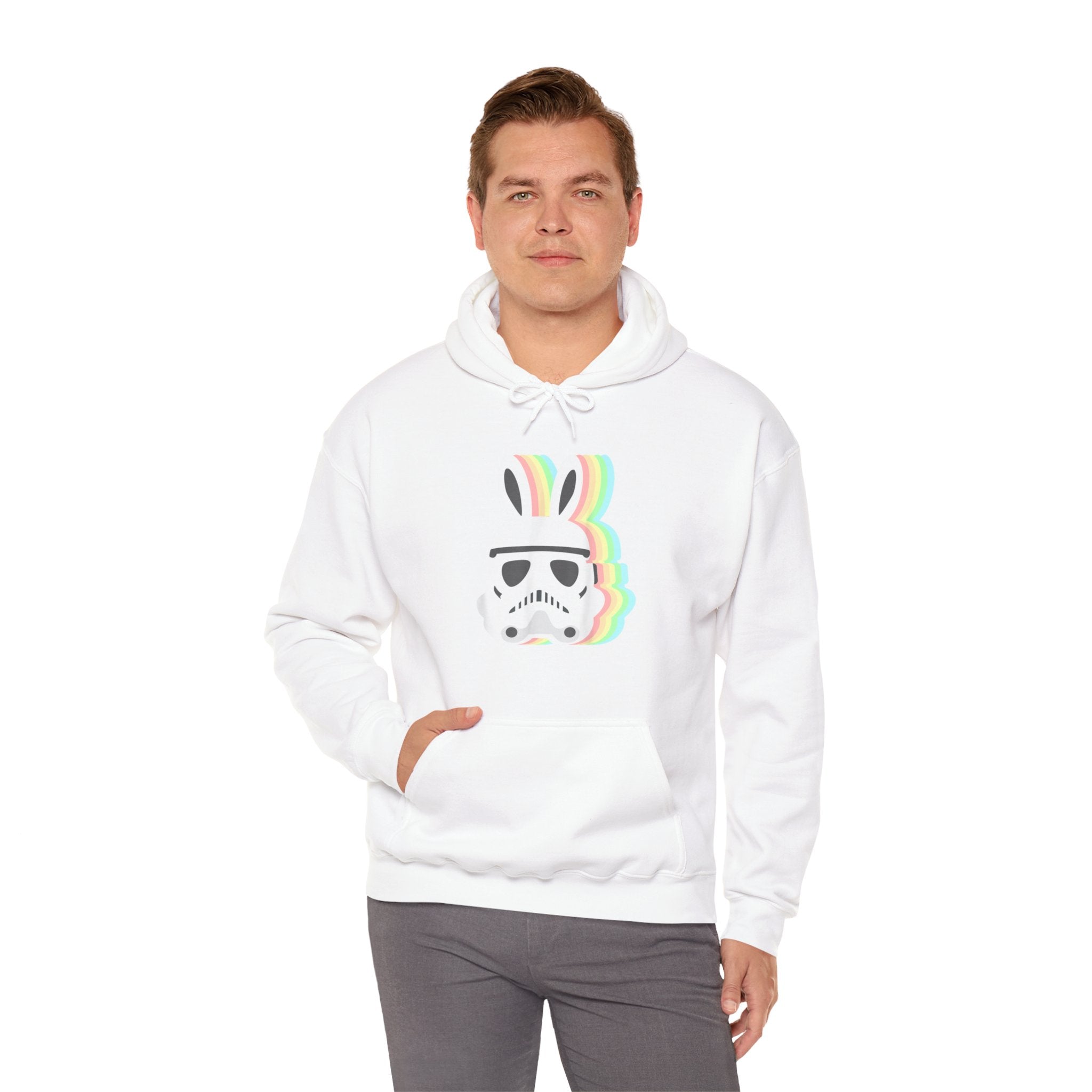 A person wearing a Star Wars Easter Stormtrooper - Hooded Sweatshirt with a graphic of an Easter Stormtrooper helmet and rainbow-colored bunny ears stands with one hand in their pocket.