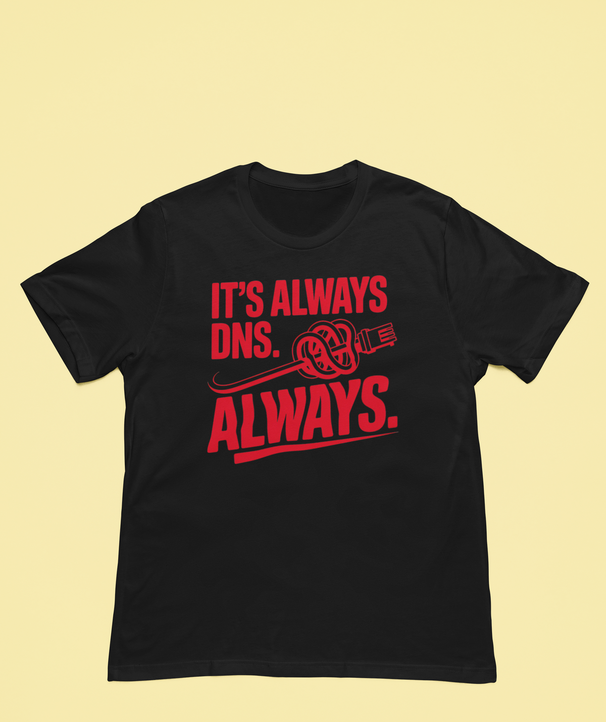 'It's Always DNS. Always.' black oversized tee flat lay on yellow backdrop, funny sysadmin gift
