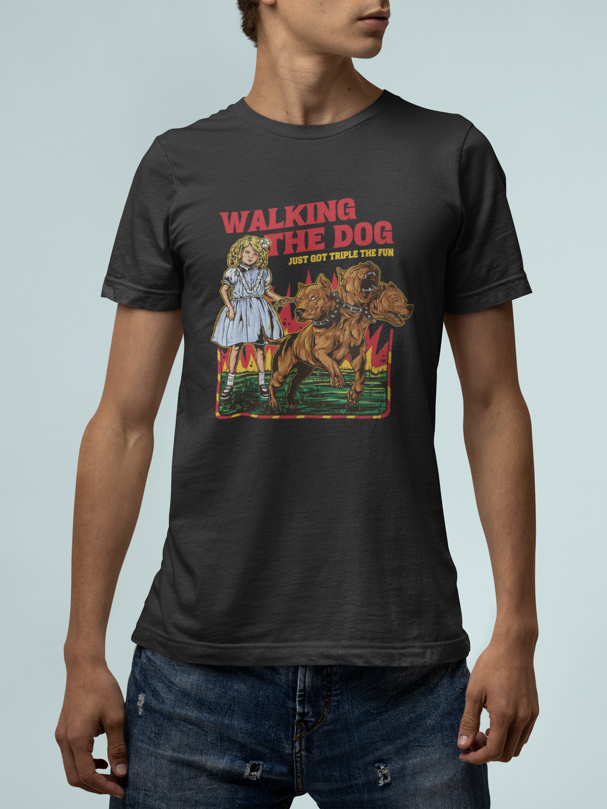 'Walking the Dog From Hell' t-shirt in black, man model wearing it against a light blue background, funny gift for dog owners