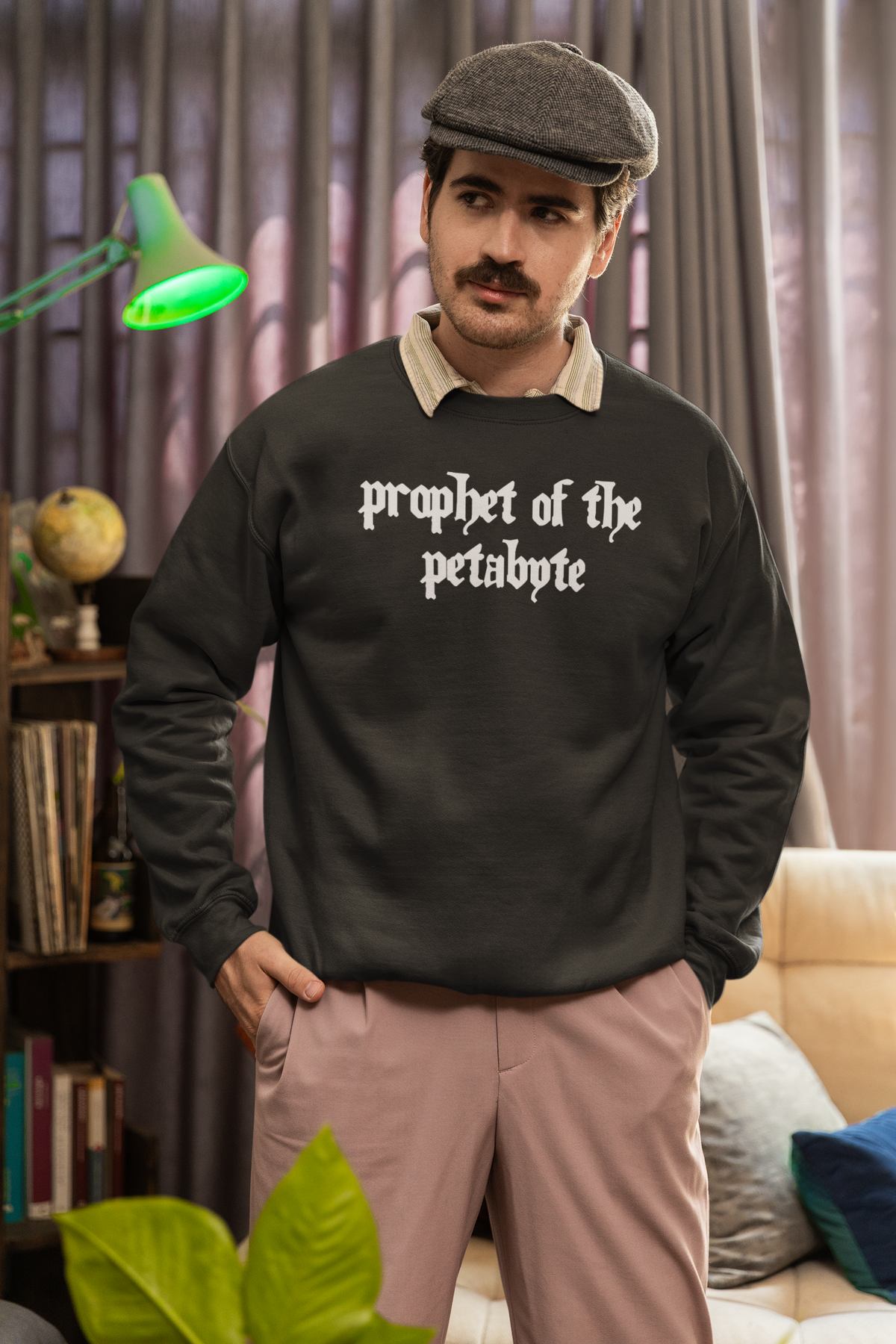 'Prophet of the Petabyte' sweatshirt in charcoal, man wearing it in a cozy study, funny data engineer gift