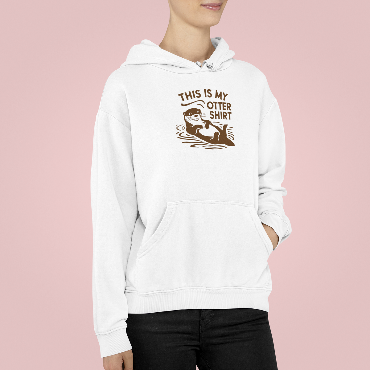 'This Is My Otter Shirt' hoodie in white, woman wearing it on a pink background, funny otter pun gift