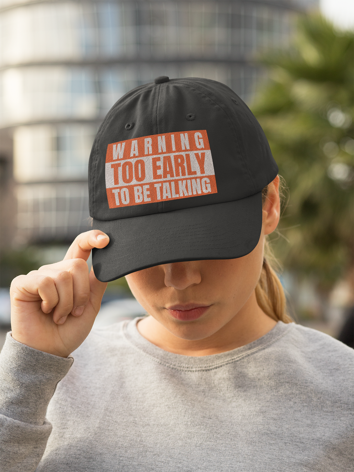 'Warning Too Early To Be Talking' dad hat in black, woman wearing it in city street, funny cap gift