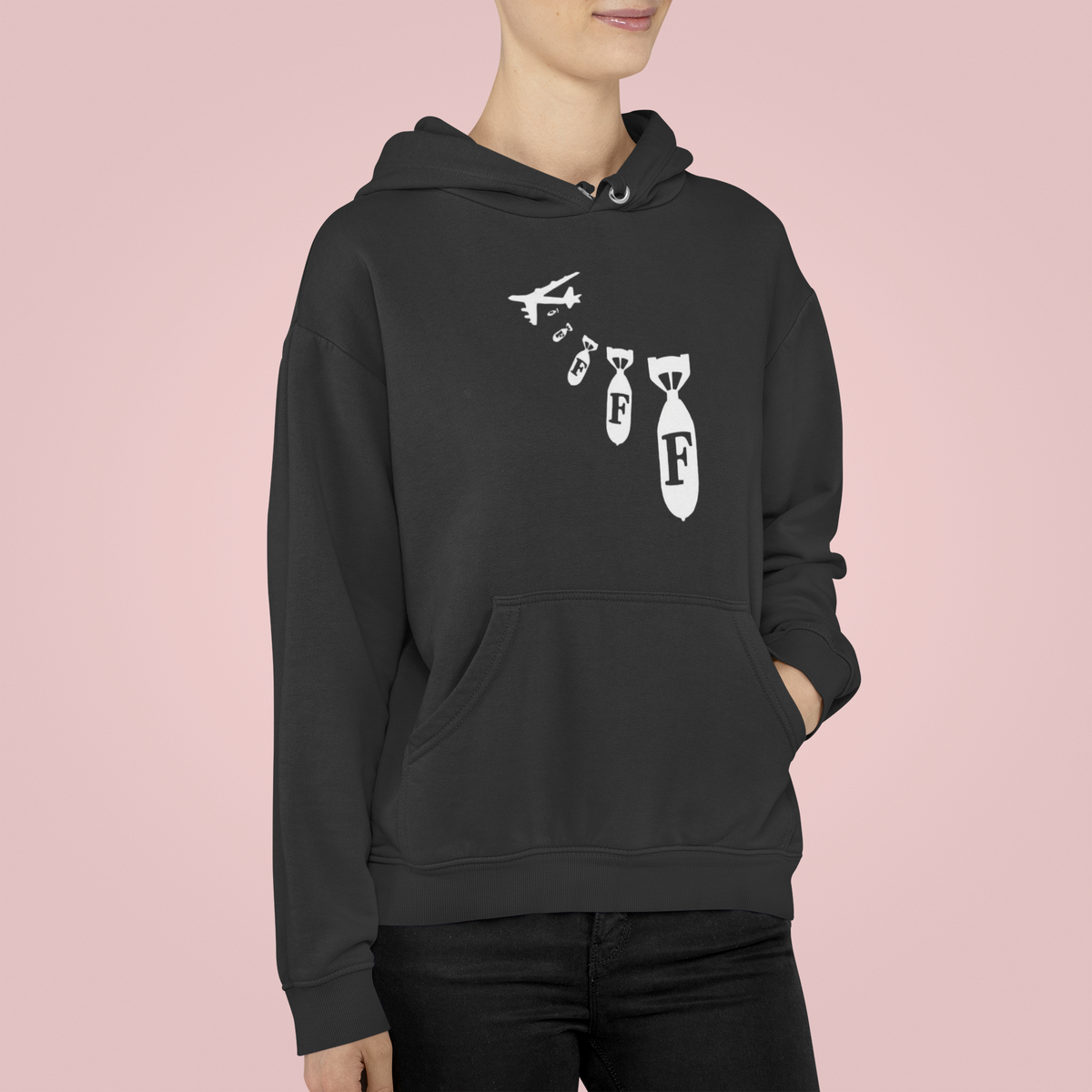 "F Bomb" hoodie in black, woman wearing it on pink backdrop, funny sarcastic gift hoodie