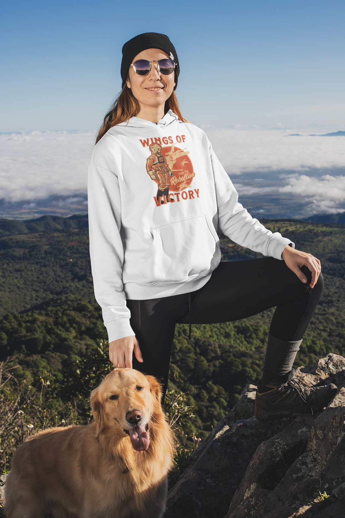 'Wings of Victory' hoodie in white, woman hiking with her dog wearing it, warrior graphic hoodie gift