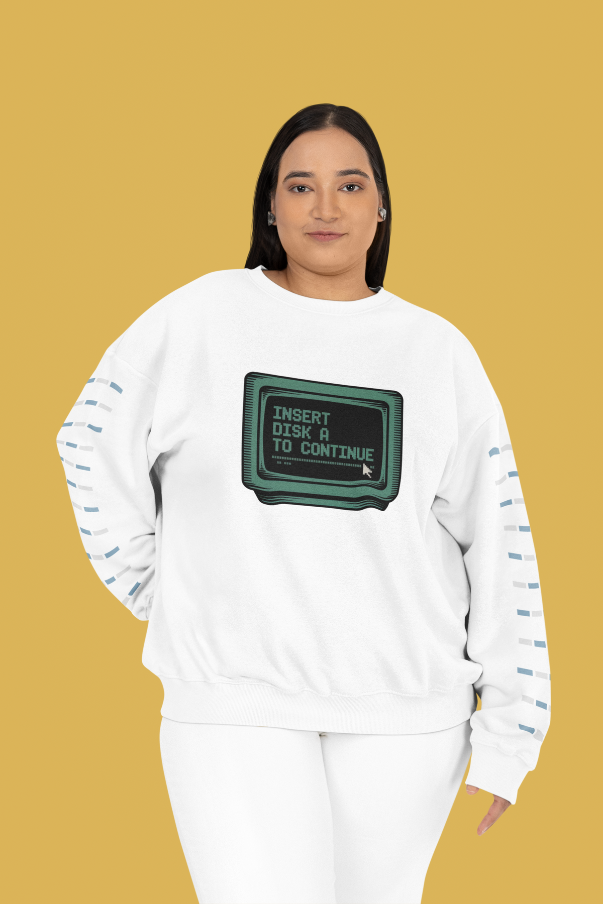 'Insert Disk A to Continue' sweatshirt in white, woman wearing it on yellow background, retro gamer gift