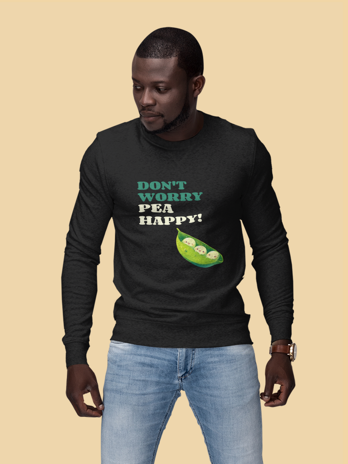 'Don't Worry Pea Happy' pea pun sweatshirt in black, man wearing it, mustard backdrop, veggie gift