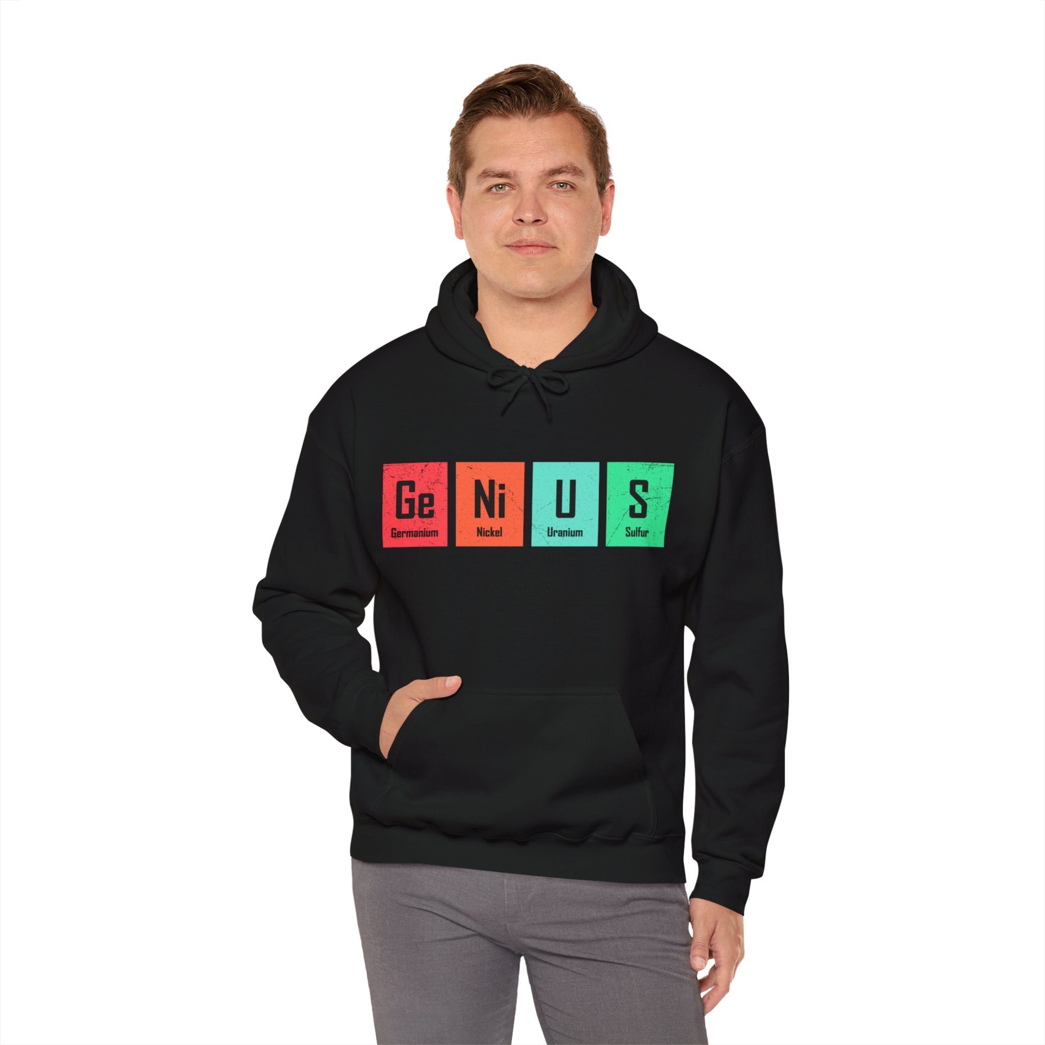 A person stands wearing a black Ge-Ni-U-S - Hooded Sweatshirt featuring a unique design with elements from the periodic table spelling "Genius," offering both style and a comfy feel.