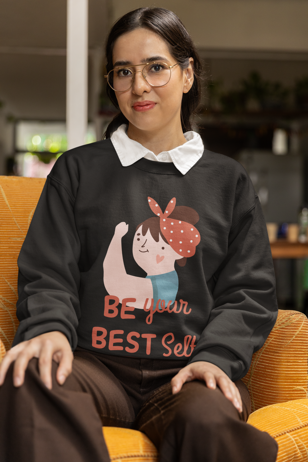 Be Your Best Self sweatshirt in black, woman sitting indoors wearing it, motivational gift