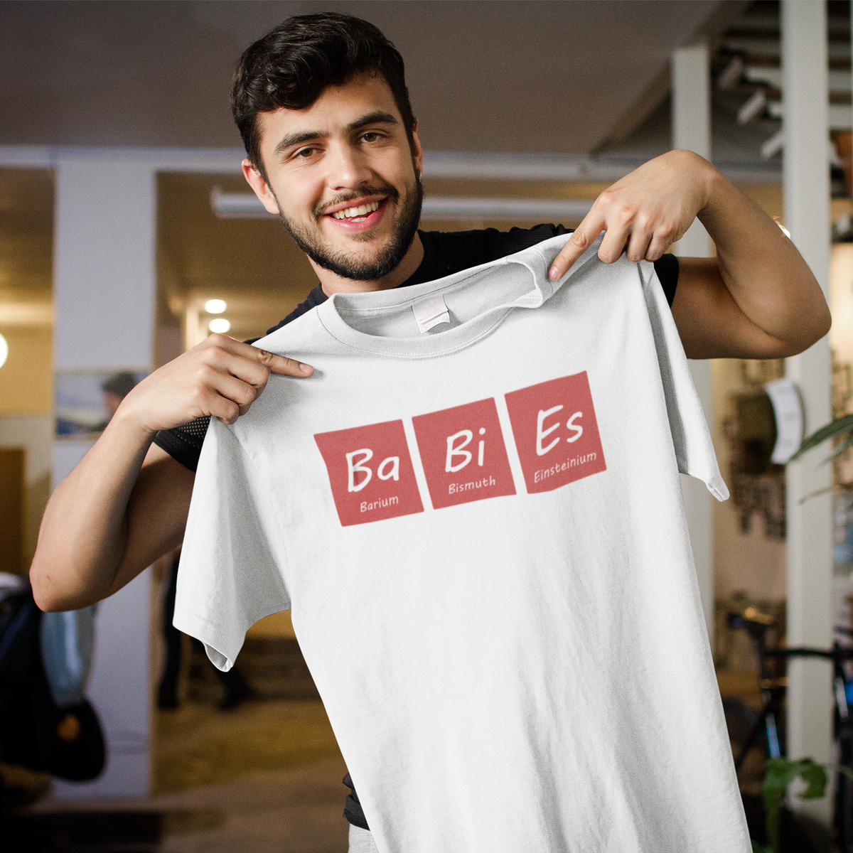 Ba-Bi-Es periodic table baby element pun graphic tee, model wearing it indoors
