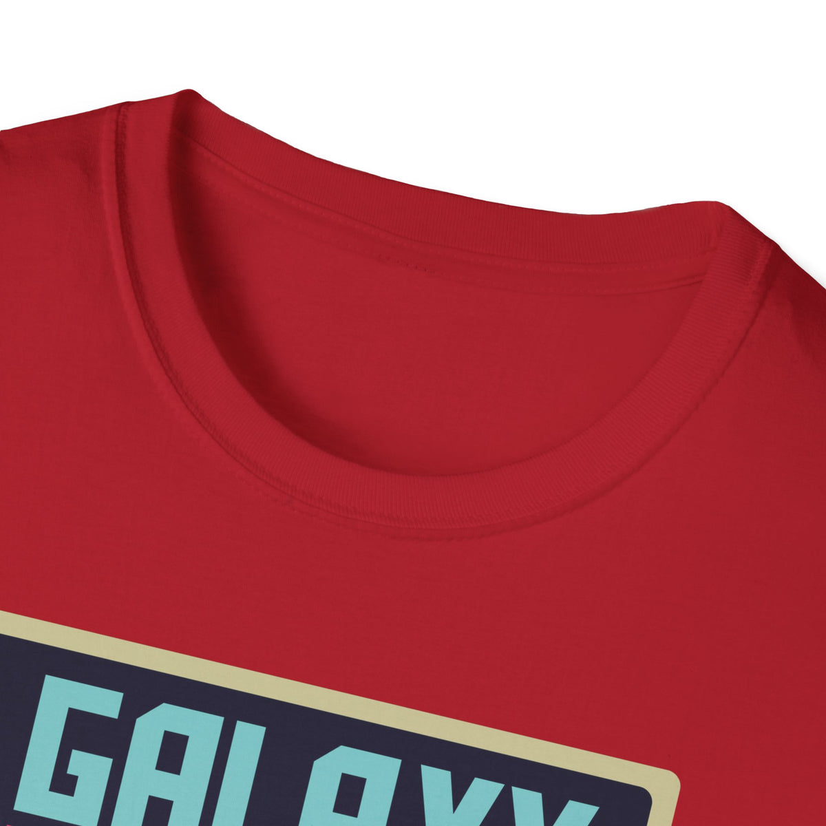 Close-up of "Galaxy Invaders" teal text print on red t-shirt collar, retro arcade graphic detail
