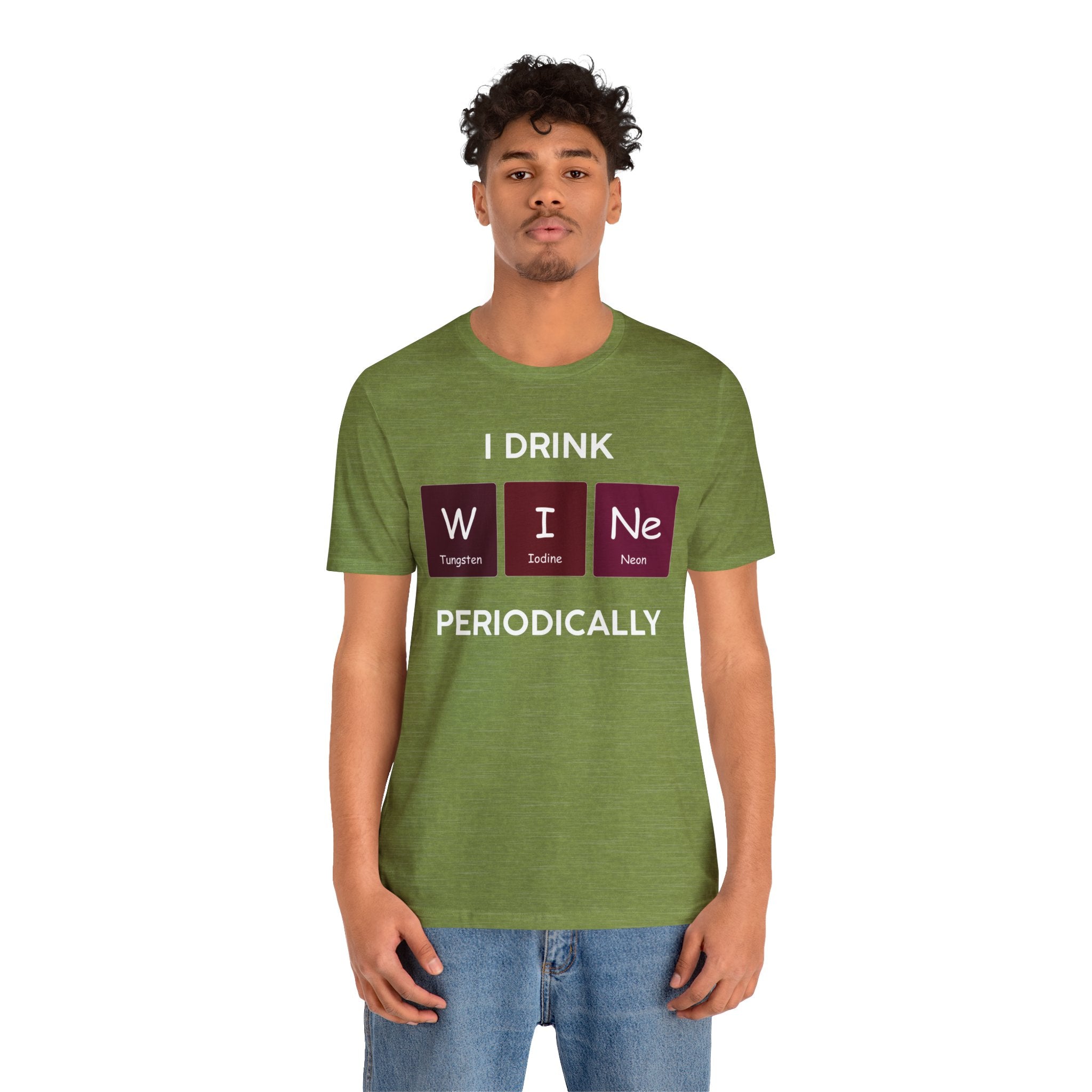 Young man in a soft cotton green t-shirt with "I Drink W-I-Ne" using periodic table elements for "wine" printed on it, paired with blue jeans, standing against a neutral background.