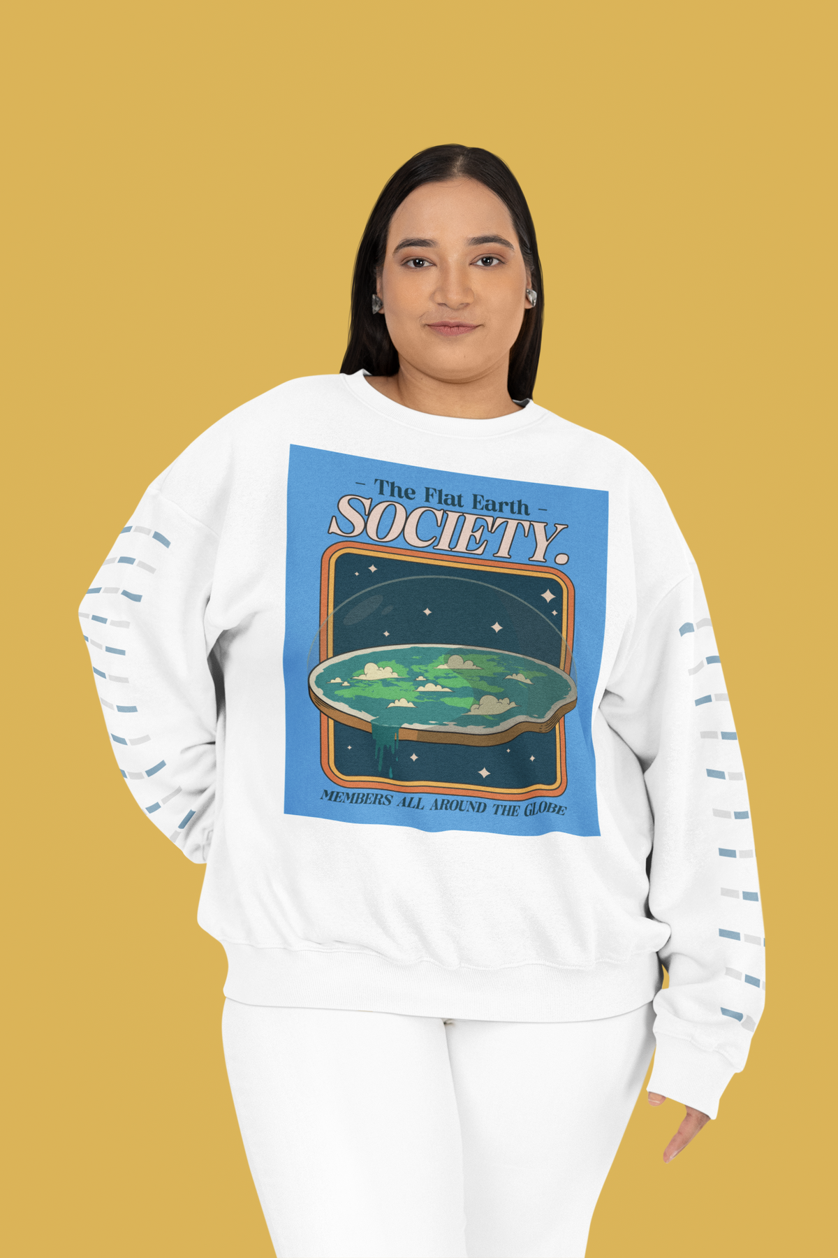 'The Flat Earth Society' sweatshirt in white, woman wearing it on mustard backdrop, funny gift