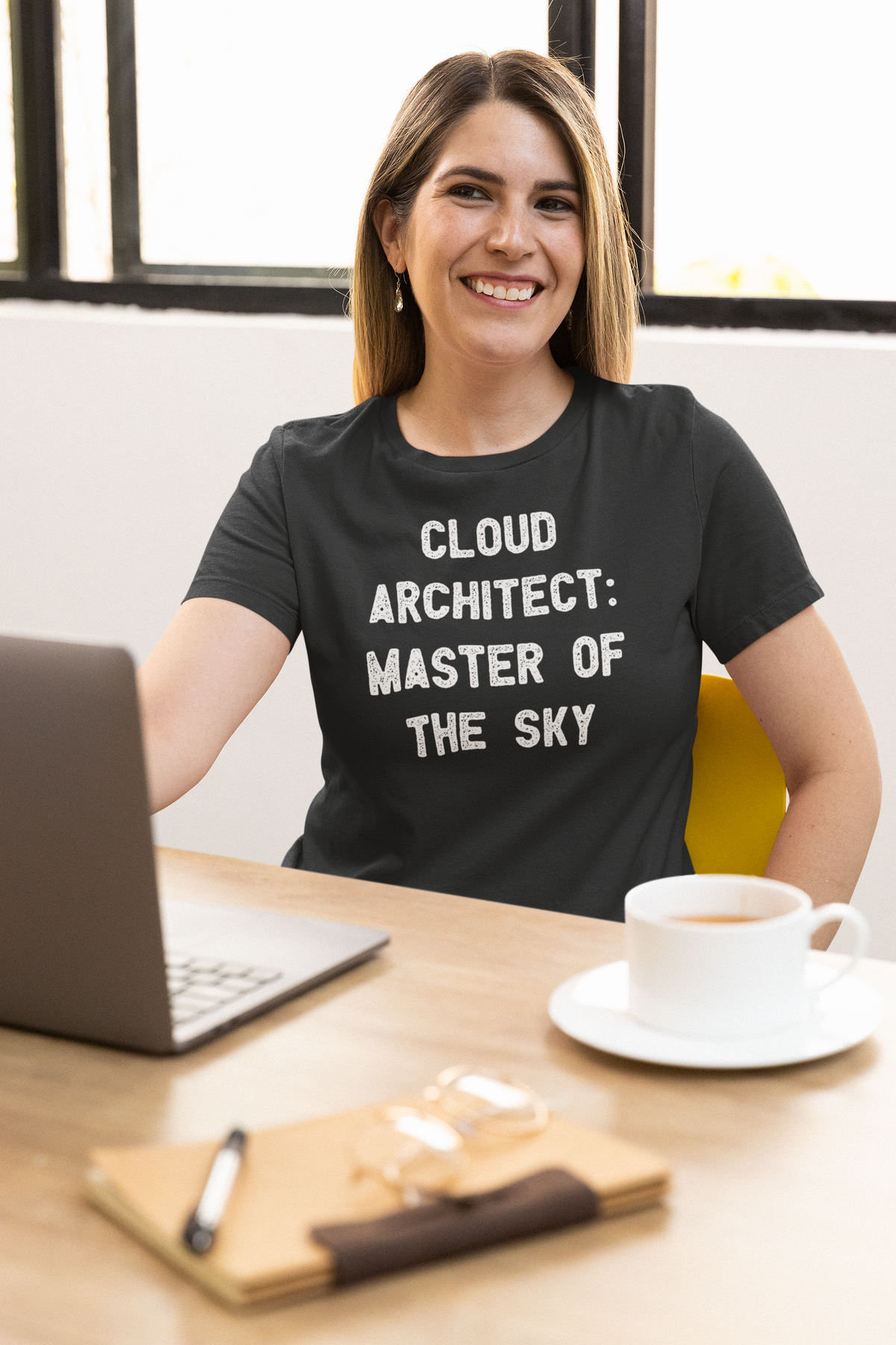 'Cloud Architect: Master of the Sky' t-shirt in charcoal, woman wearing it at desk, funny gift for tech professionals