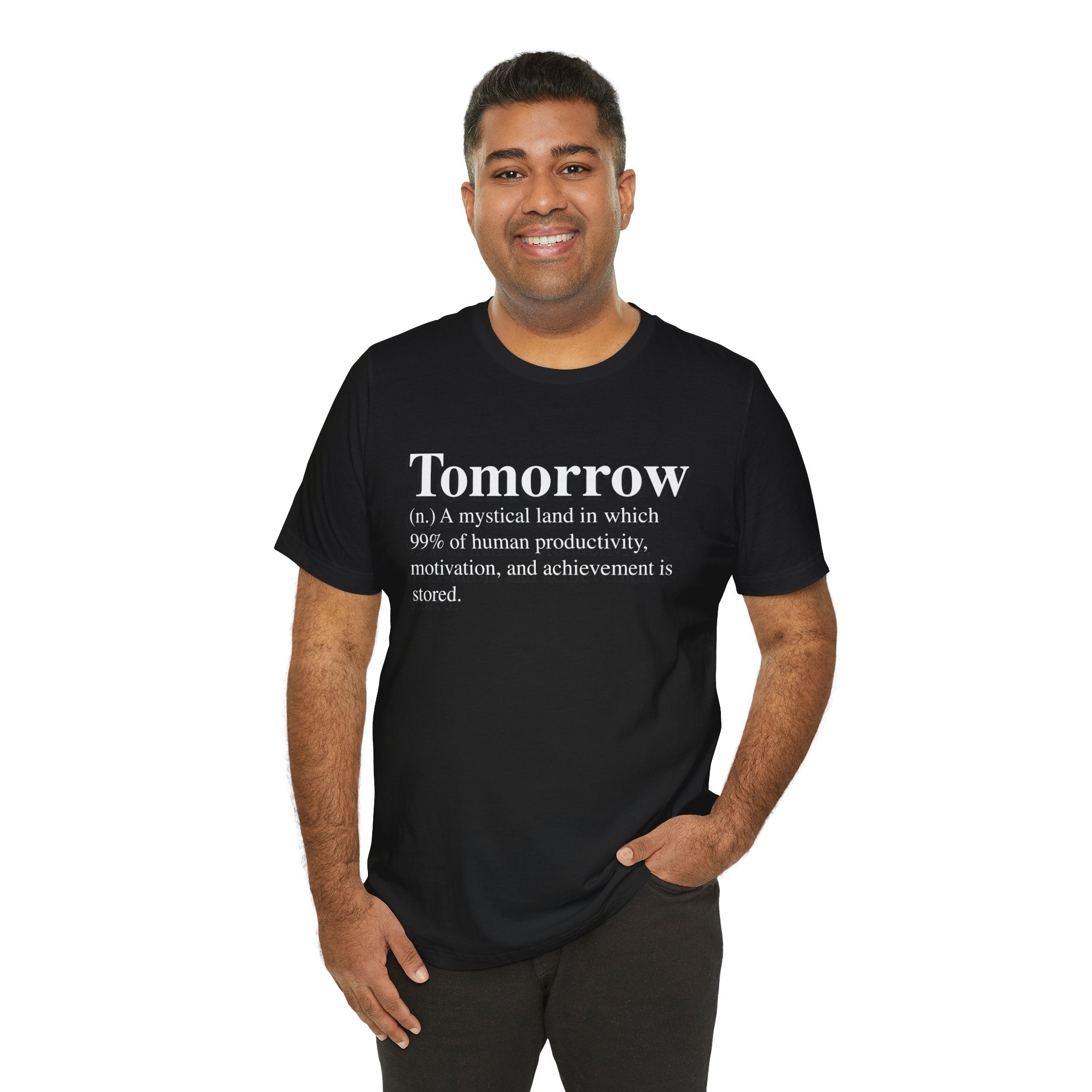 A man smiling and wearing a soft cotton black Tomorrow T-Shirt with a sarcastic definition of "tomorrow" printed on it.