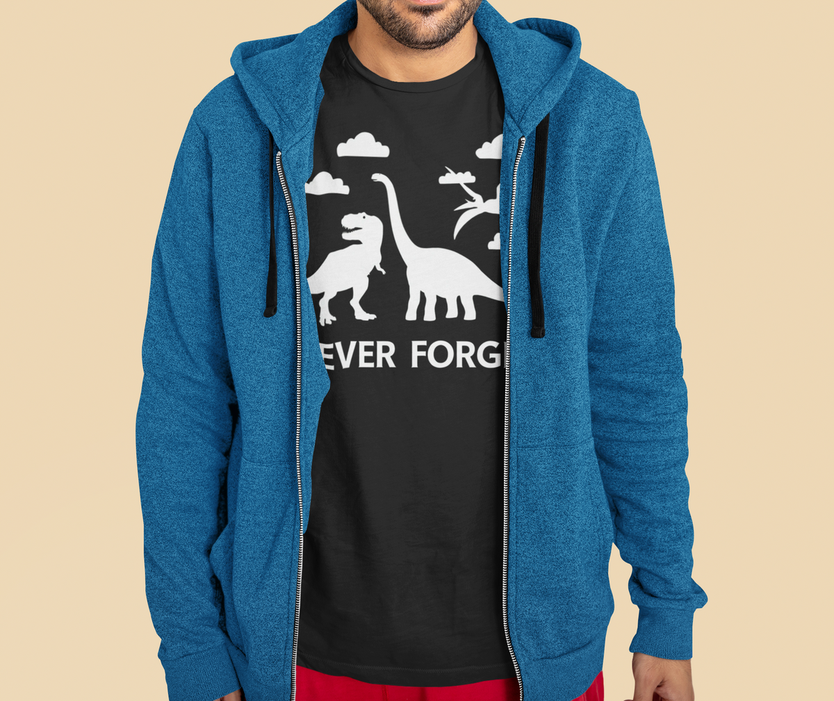 'Never Forget' dinosaur t-shirt in black, man wearing it under a blue zip hoodie outdoors, funny science gift