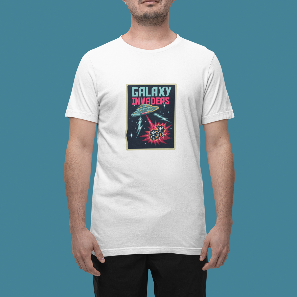 'Pixel Galaxy Invaders' t-shirt in white, man wearing it in a studio, T-Shirt mockup, Geekpsters