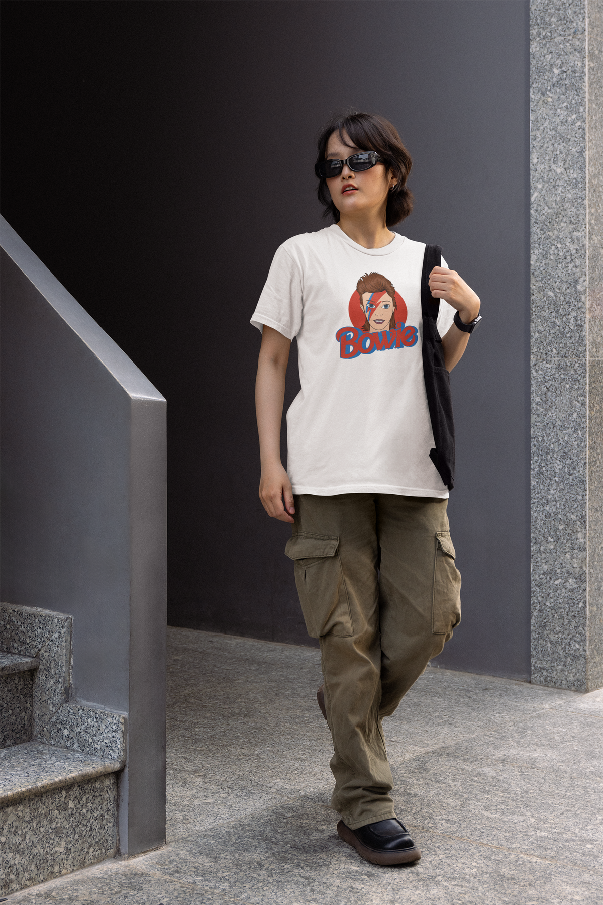 Bowie lightning bolt graphic tee in white, woman walking wearing it in cargo pants, funny music gift