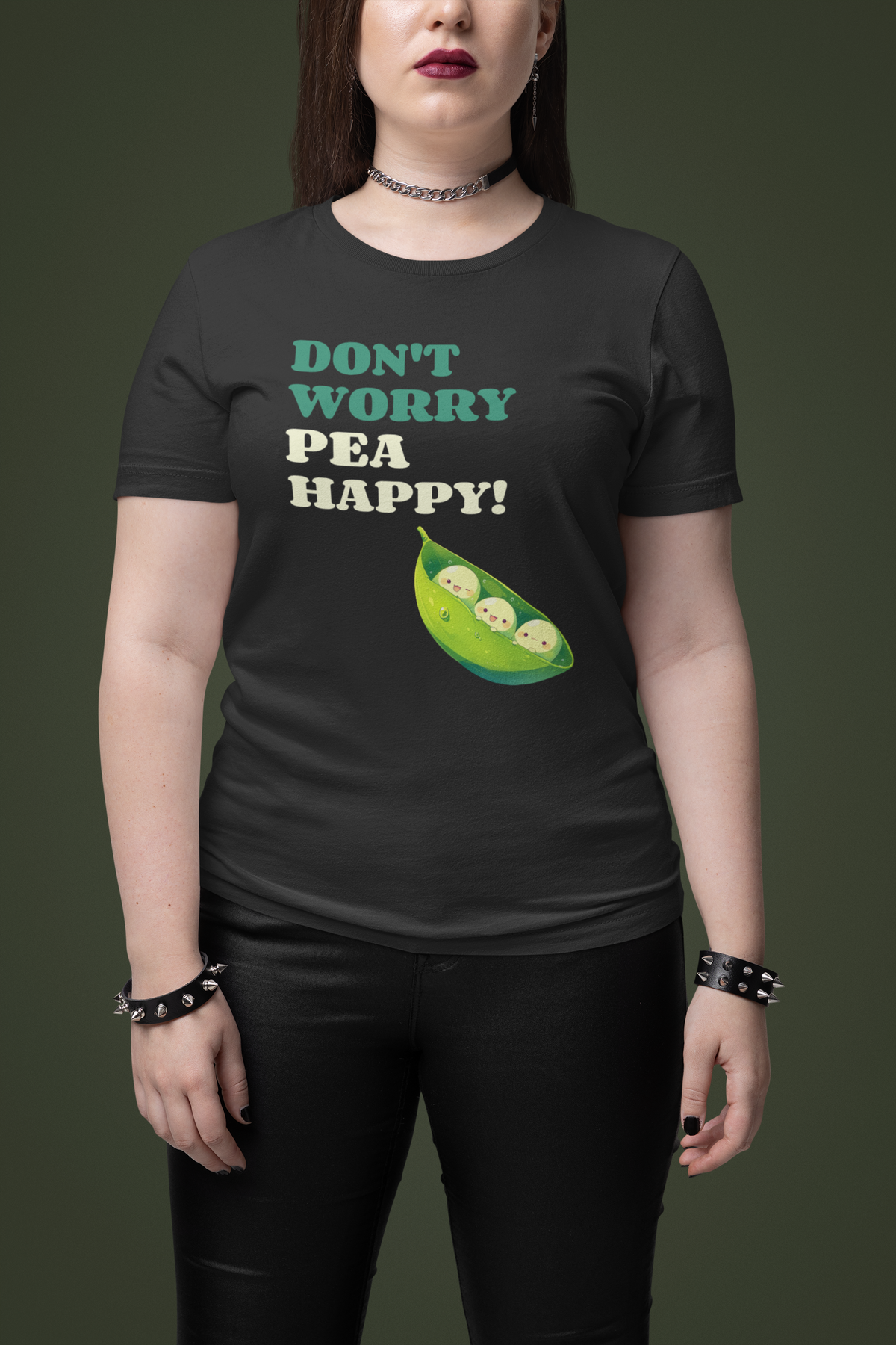 'Don't Worry Pea Happy' pea pun t-shirt in black, woman wearing it, green backdrop, veggie pun gift