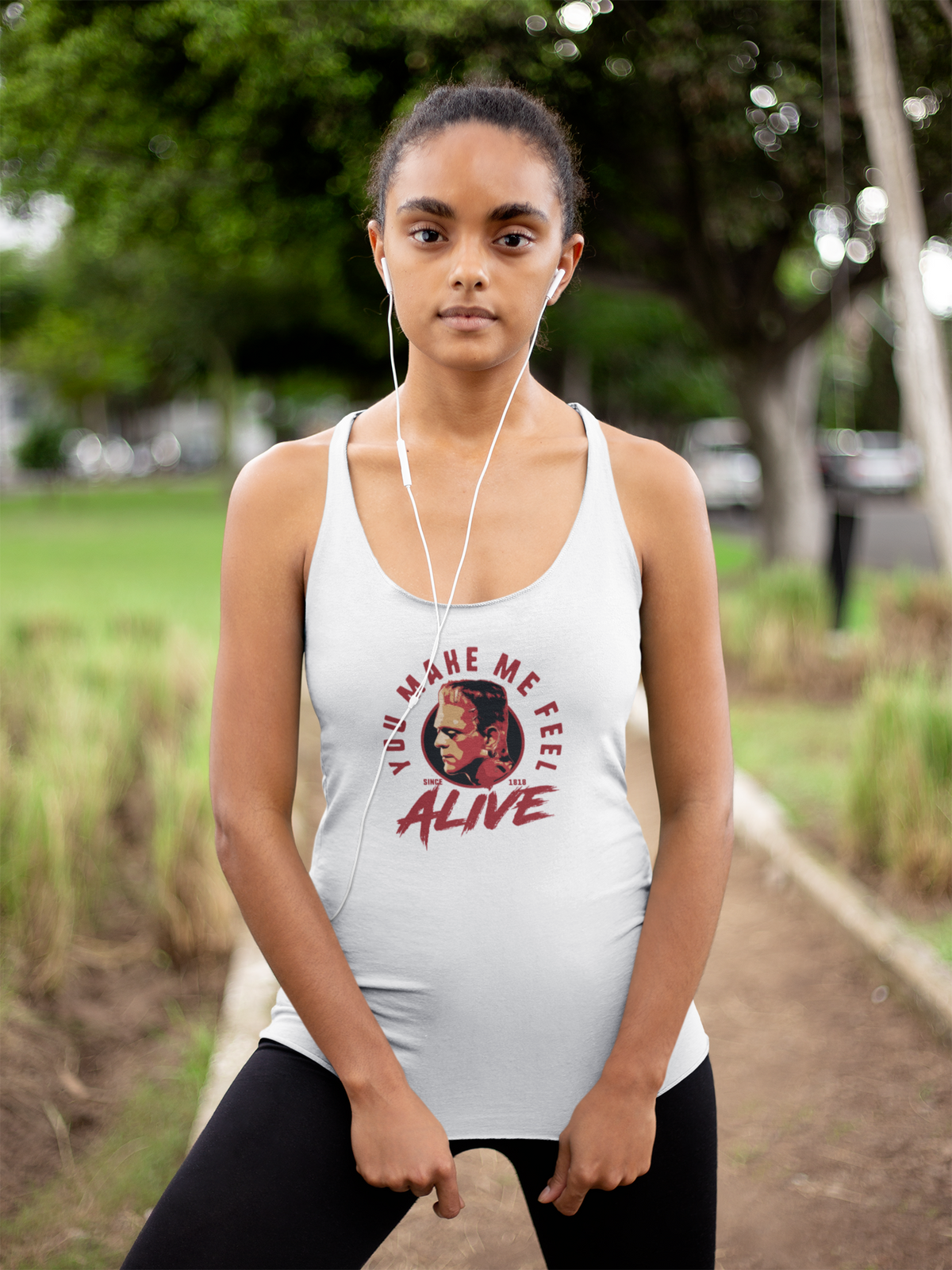 'You Make Me Feel Alive Women's Tank' in white, woman in a park, Tank Top mockup, Geekpsters